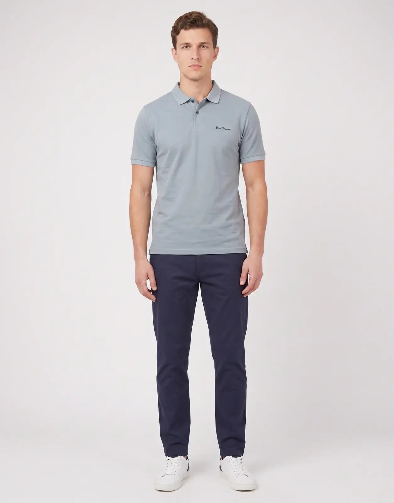 A male model wears the Ben Sherman Ben Polo in Misty Grey, a classic short-sleeve polo shirt with a two-button placket and