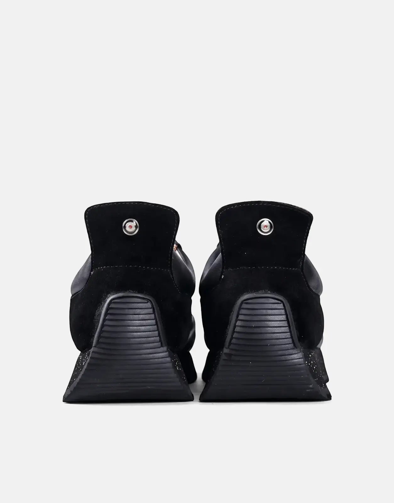 Rear view of two Ben Sherman Henry black leather and suede lace-up shoes, featuring textured soles and a distinctive heel