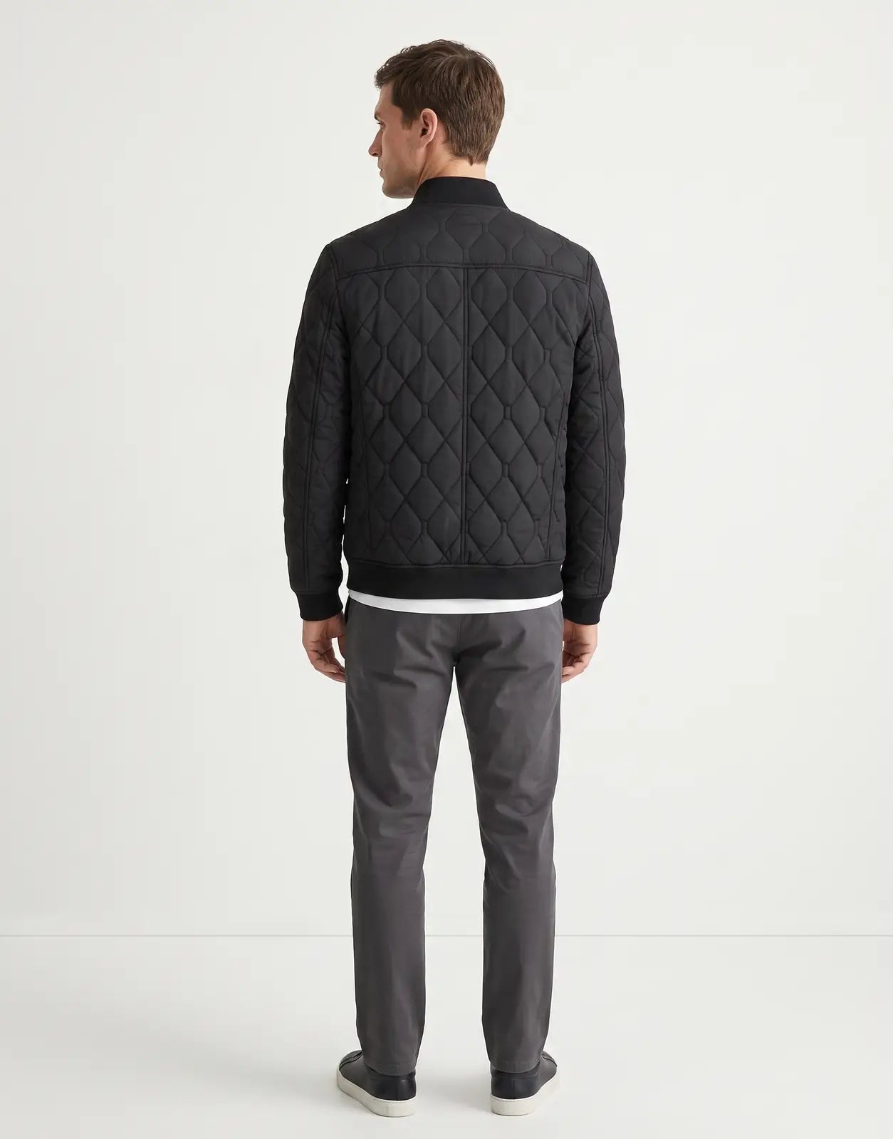 Back view of a Ben Sherman Quilted Black Bomber Jacket, featuring a distinct diamond quilted pattern, ribbed collar, cuffs,