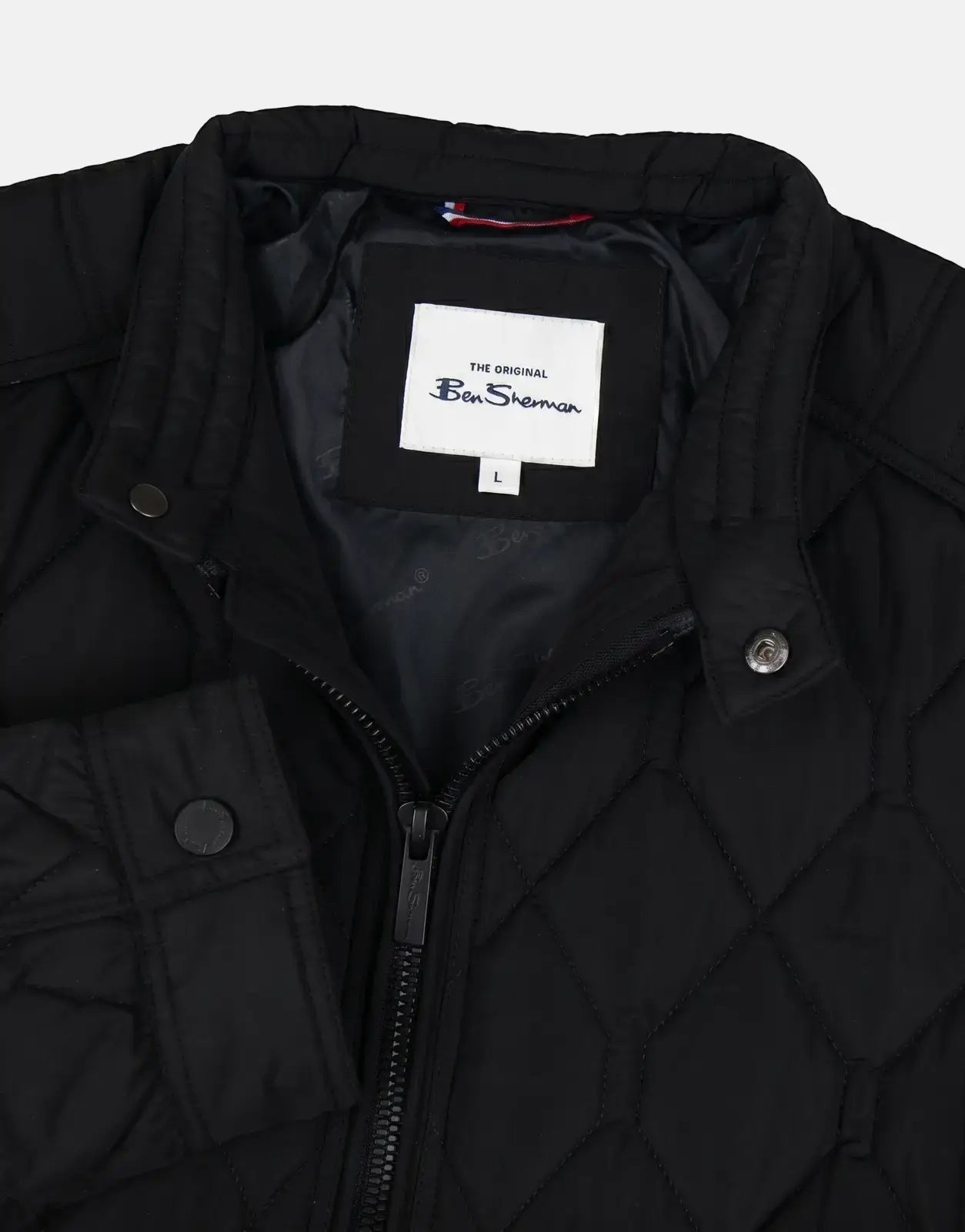 Ben Sherman quilted black bomber jacket close-up showing diamond stitching, zip front and snap collar detail.