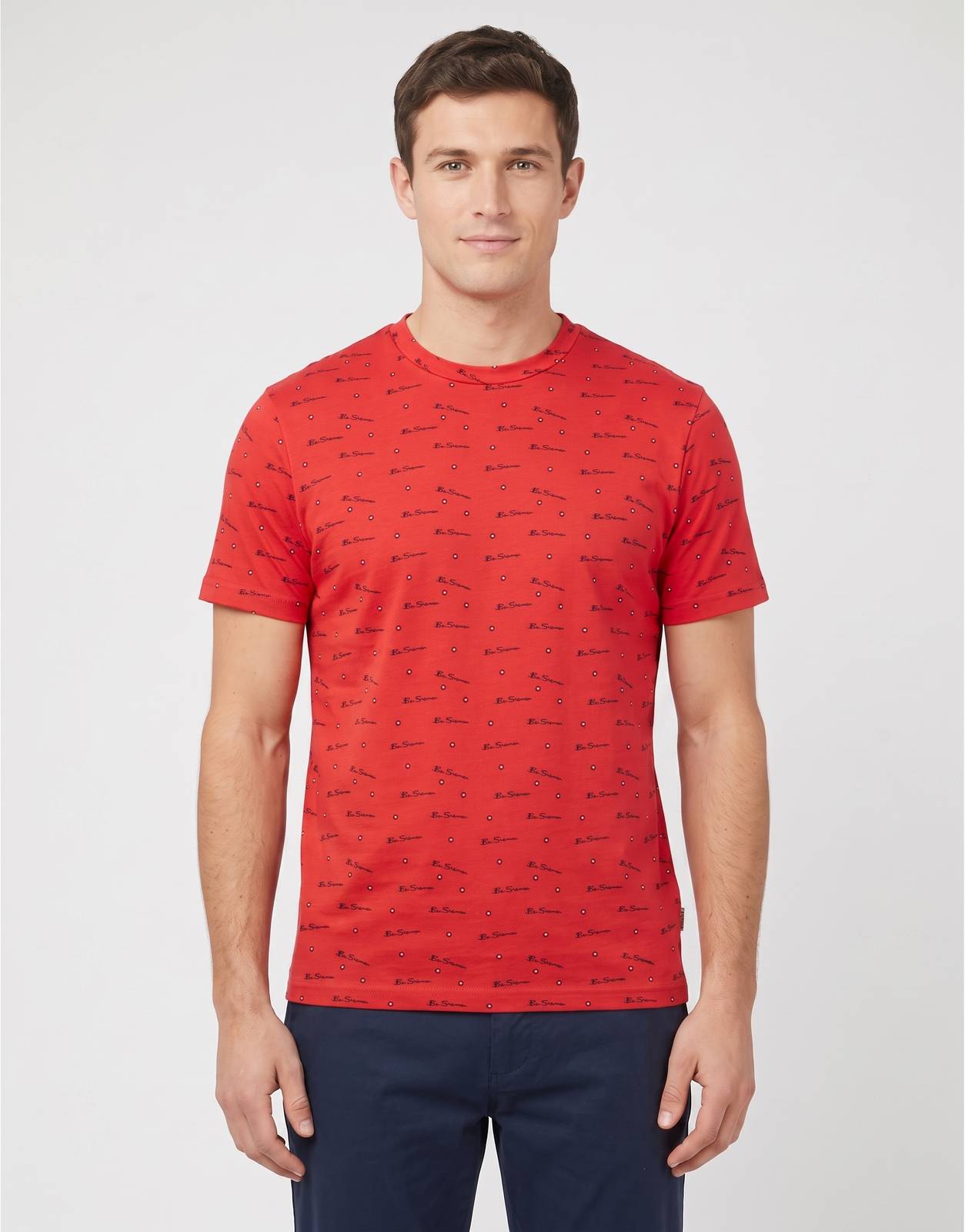 Front view of a Ben Sherman Tar Aop Red T-Shirt for men, featuring an all-over black script logo print and a classic crew
