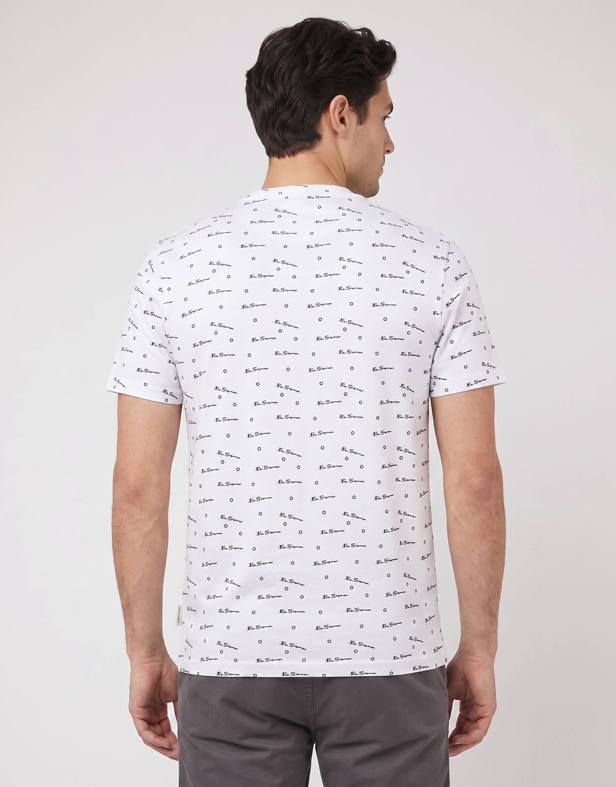 Men's Ben Sherman Tar Aop White T-shirt, featuring an all-over black logo print, photographed from the back on a model.