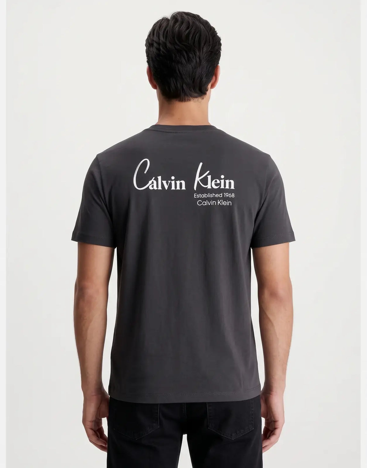 Calvin Klein 30s Wholesale Jeans Graphic T-Shirt in charcoal gray, features large white back graphic with Calvin Klein logo