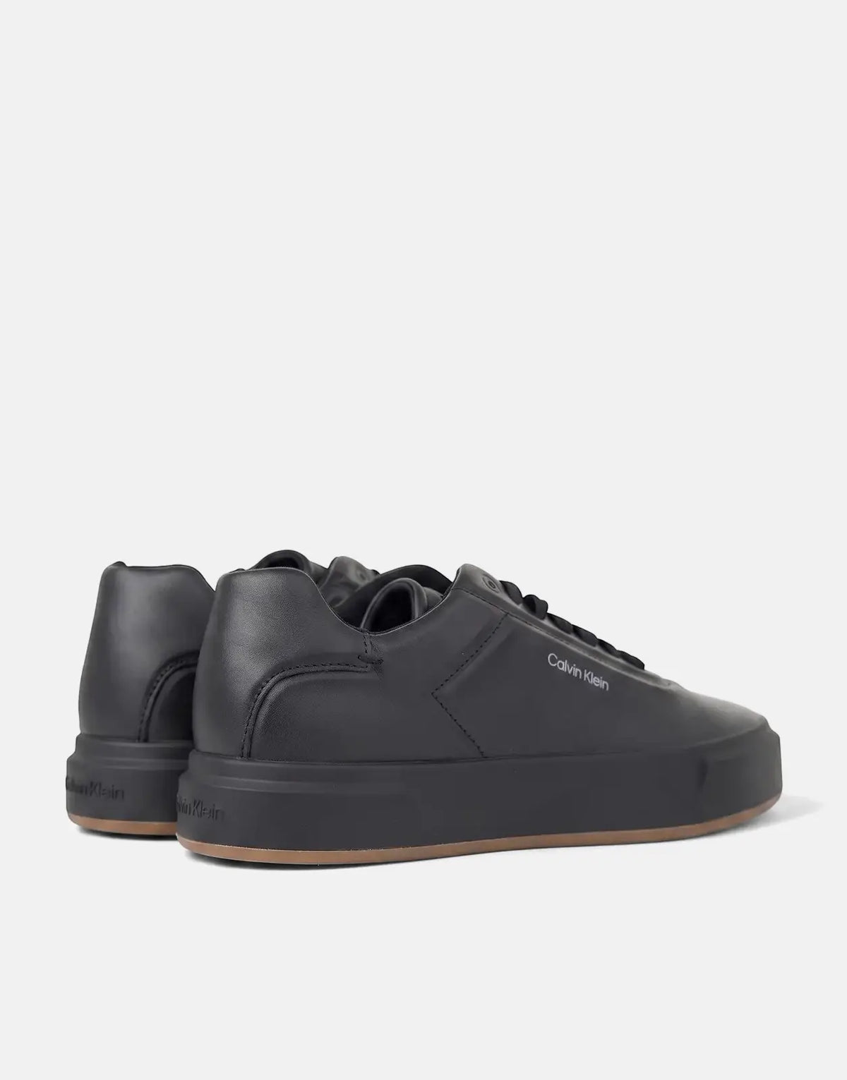 Black Calvin Klein Basket Cupsole Oxford lace-up sneakers, side view, with visible branding and brown gum sole.