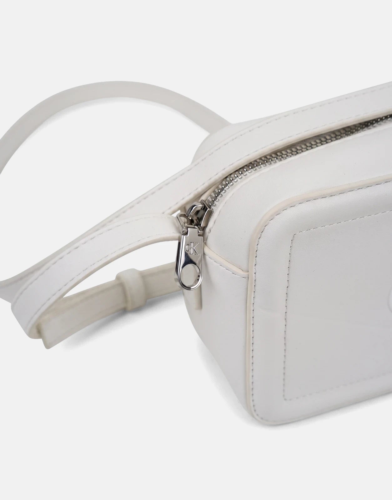 Calvin Klein Bold CK White Camera Bag in white leather with a silver zipper and compact, versatile design for everyday use.
