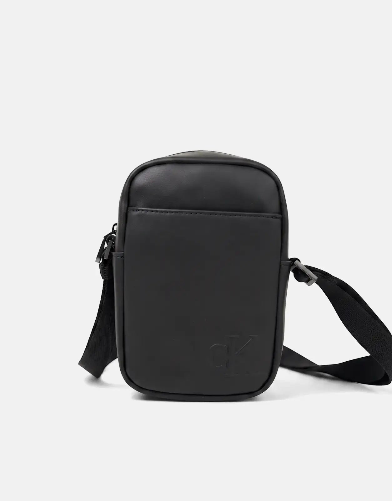 Black Calvin Klein Bold Slim Reporter Bag, a sleek compact shoulder bag with an embossed CK logo and an adjustable strap.