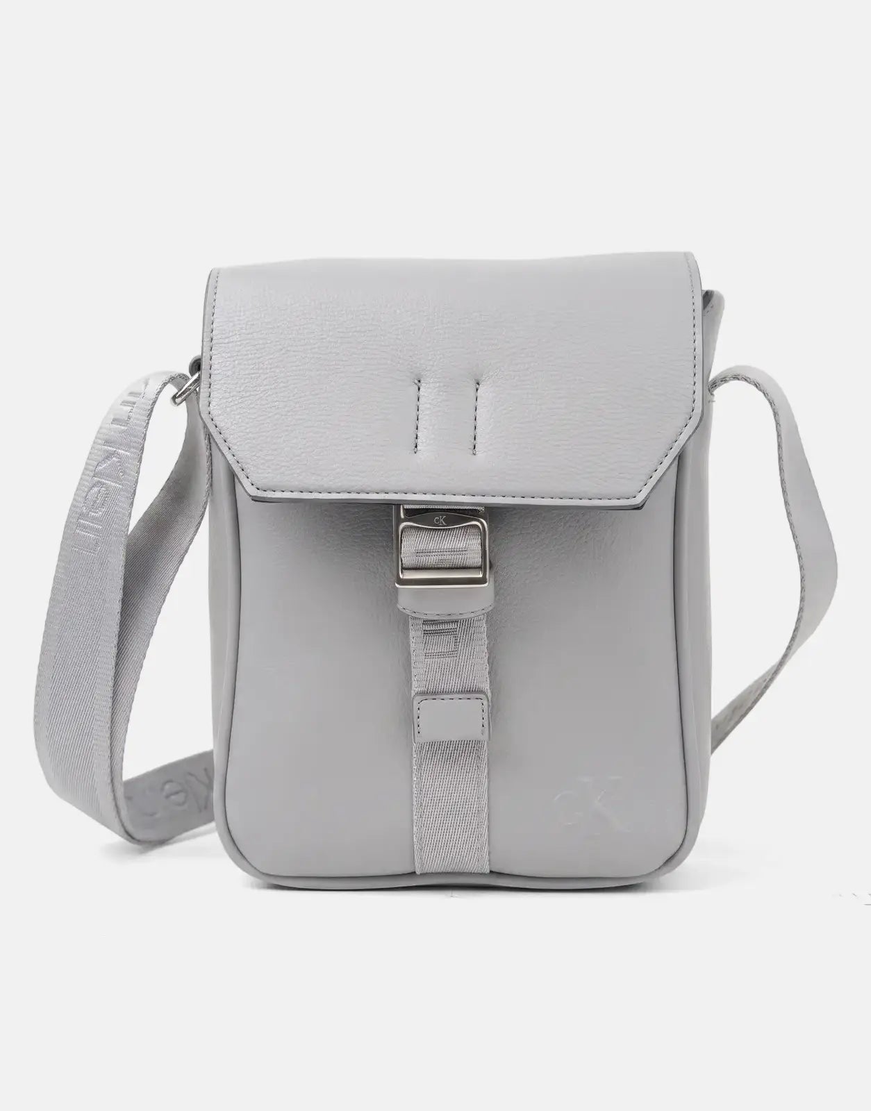 Gray Calvin Klein Cargo Flap Reporter Bag in pebbled faux leather, featuring a front flap with a silver buckle closure.