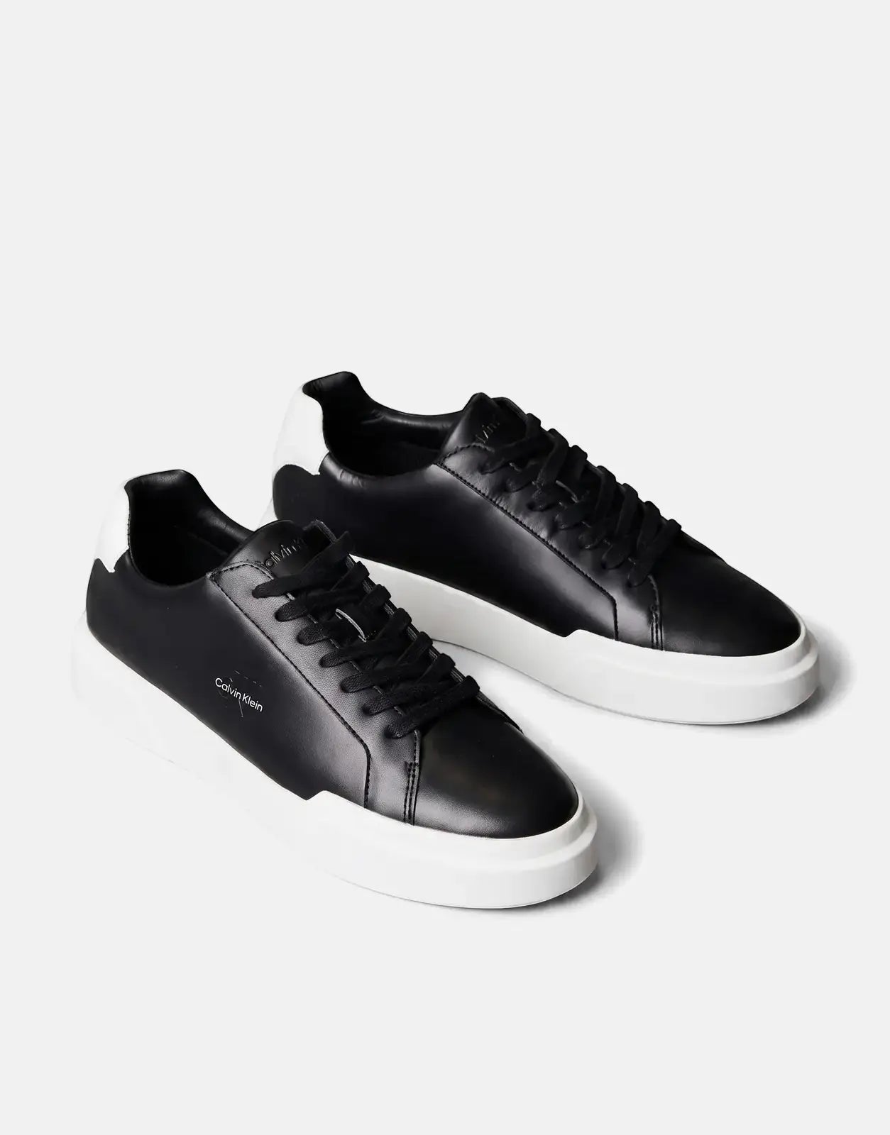 Calvin Klein Chunky Cupsole sneakers, crafted from black and white leather, presented in an angled studio shot.