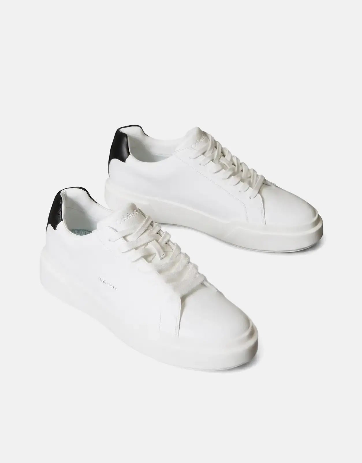 A pair of white Calvin Klein Chunky Cupsole Sneakers with black heel accents, shown from an angled side view.
