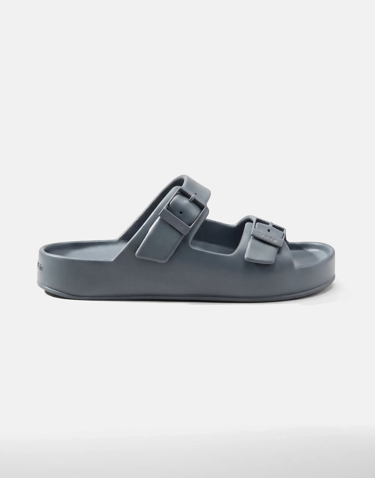 A single Calvin Klein Ergon Eva Double Bar sandal in blue-grey, featuring two adjustable straps and a thick sole, shown from