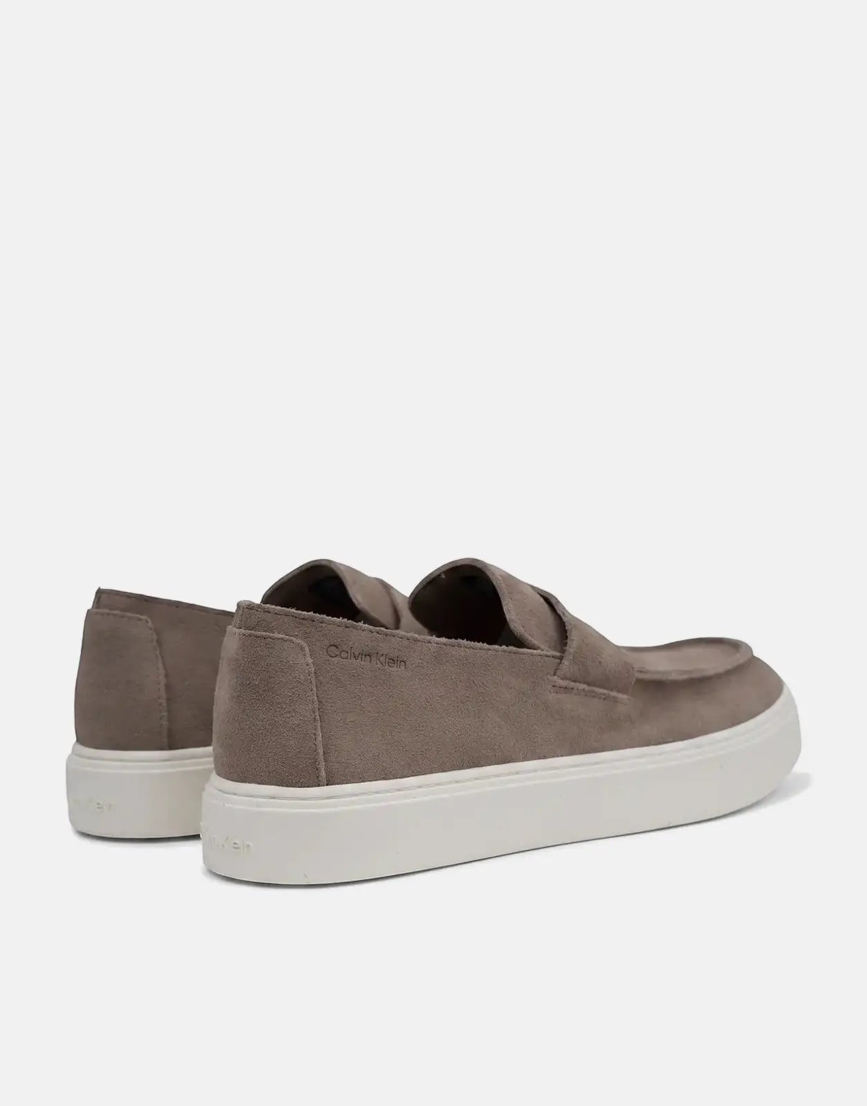 A pair of Calvin Klein Hybrid Clean Cup taupe suede loafers with white soles, viewed from a side perspective.
