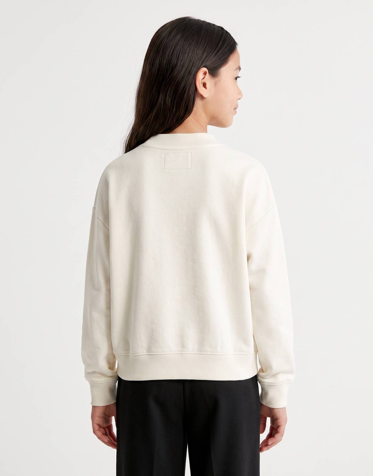 Calvin Klein Kids Script Logo Sweatshirt in off-white, shown from the back on a model, featuring a comfortable crew neck and