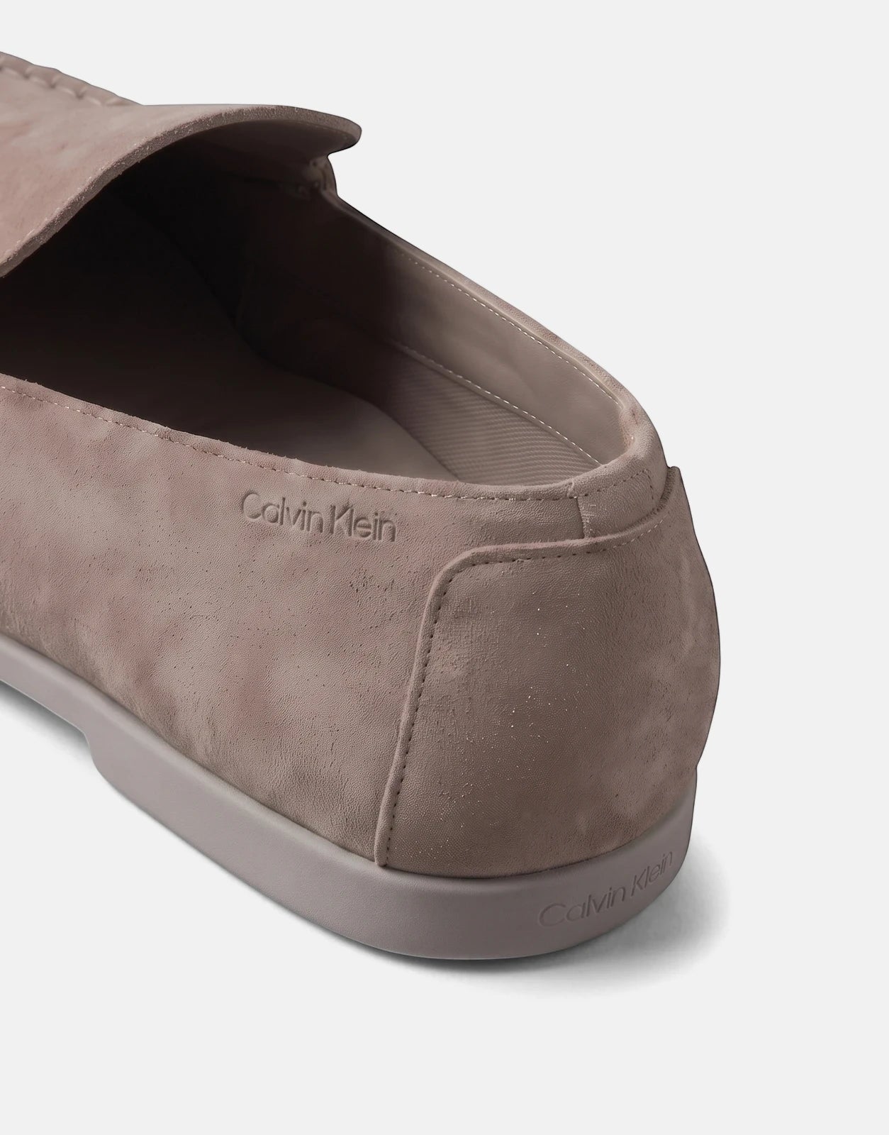 Close-up of a Calvin Klein Low Prof Taupe Loafer, showcasing its suede-like texture and embossed logo detailing on the side.