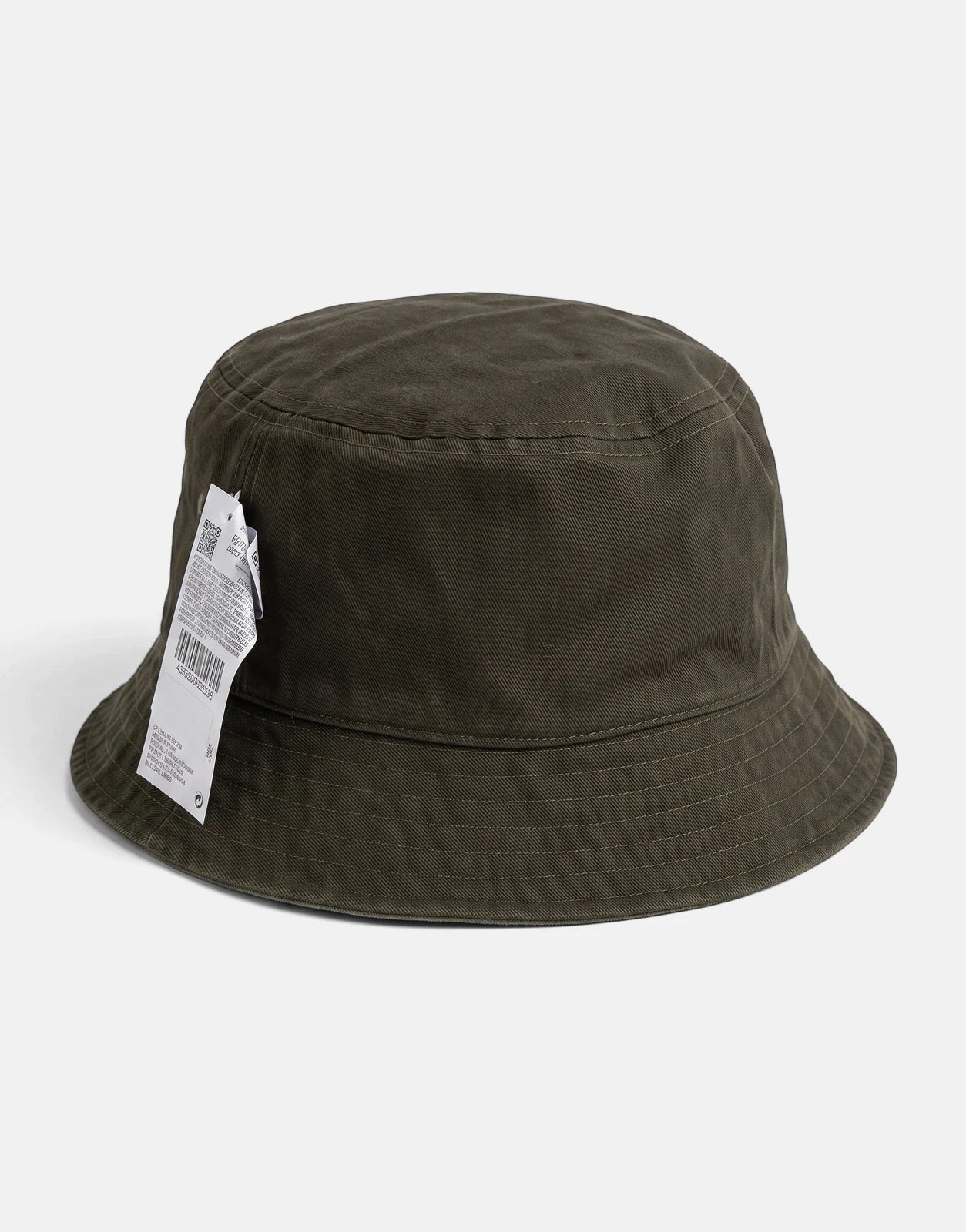 Front view of a dark green Calvin Klein washed material reversible bucket hat with visible stitching and a tag hanging from