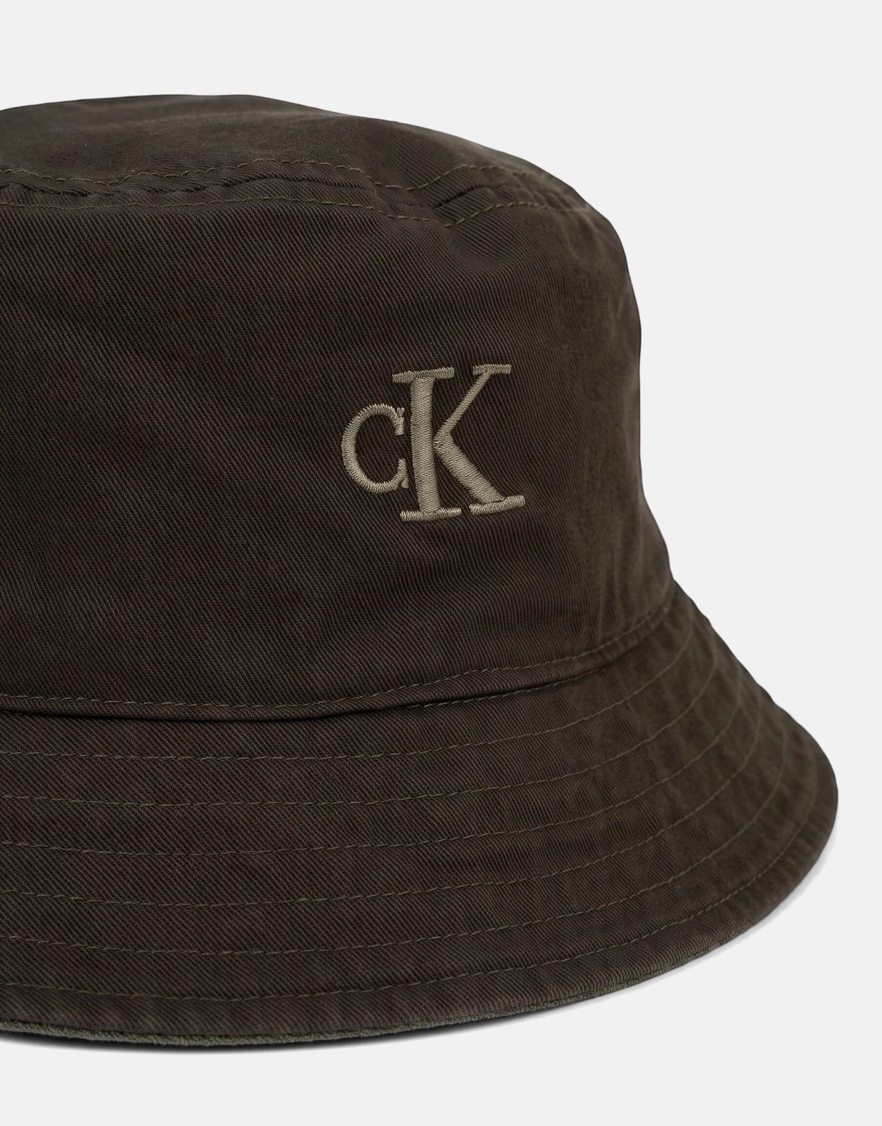 Dark olive green Calvin Klein reversible bucket hat made from washed material with an embroidered CK logo.