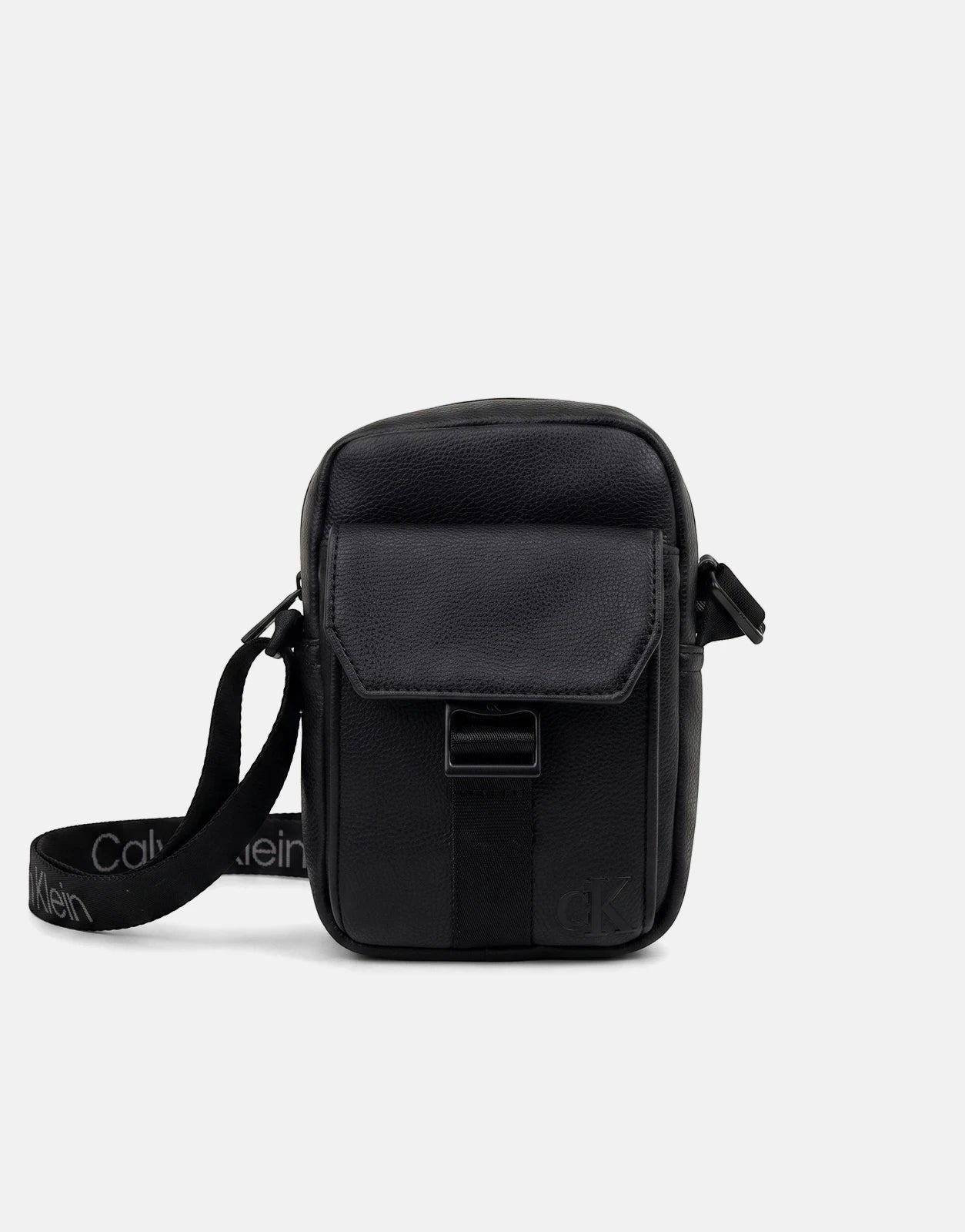 Black Calvin Klein slim reporter bag made of faux leather with a webbing strap featuring the brand logo, front flap pocket,