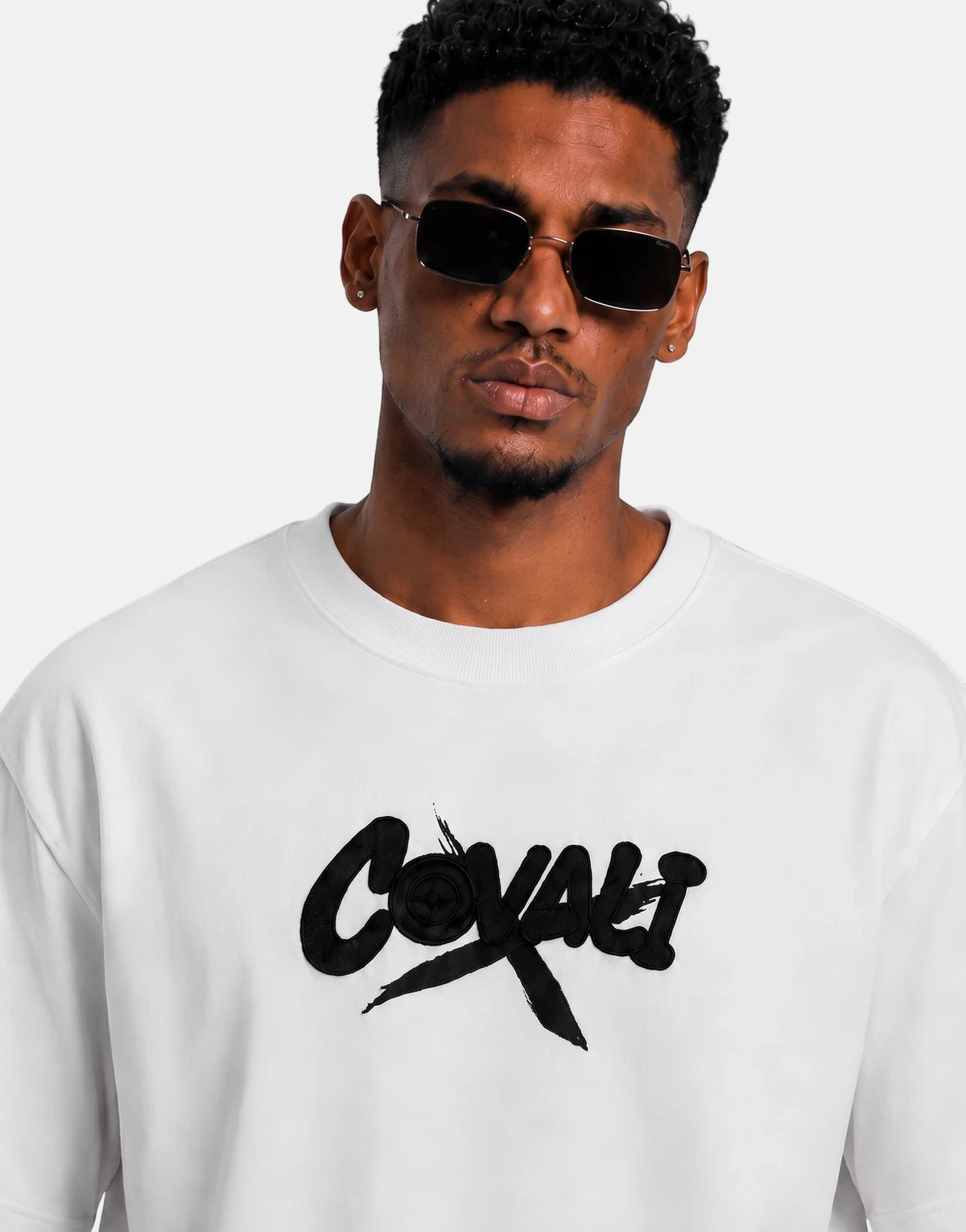 Covali Denimo White T-Shirt worn by a man, featuring a black textured 'Covali' logo on a white background.