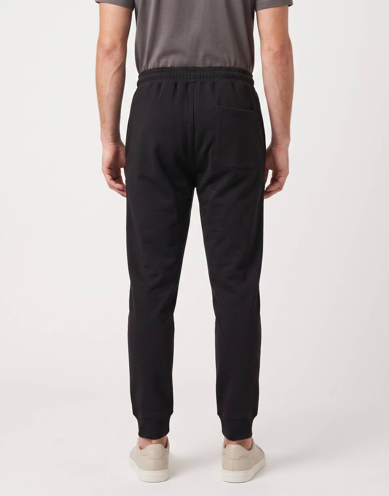 Covali Italiano-Sp Sweatpants in black, shown from the back on a male model, featuring an elasticated waist and cuffed hems.