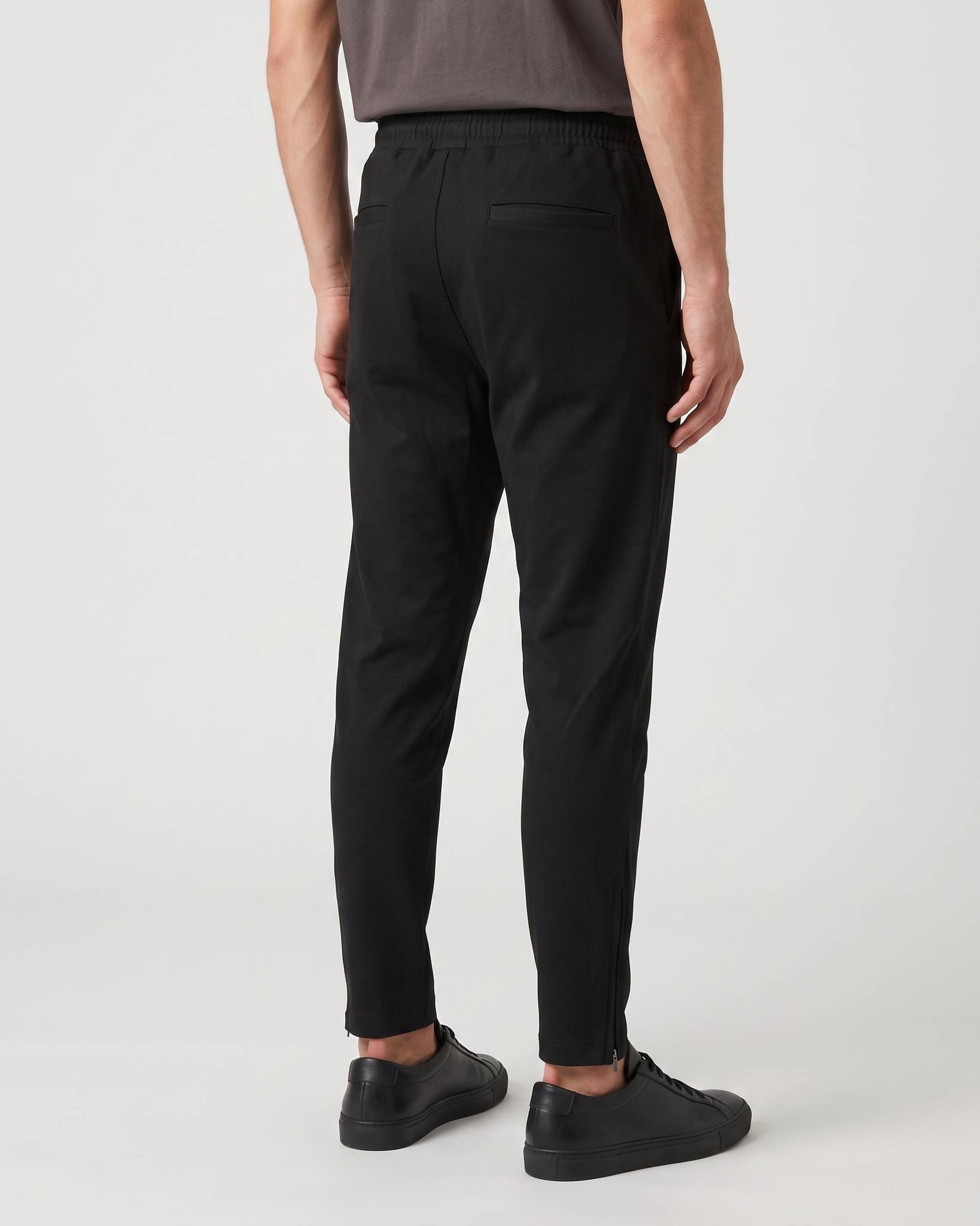 Back view of black Covali Nero-SP Sweatpants worn by a male model, highlighting the comfortable fit and clean design.