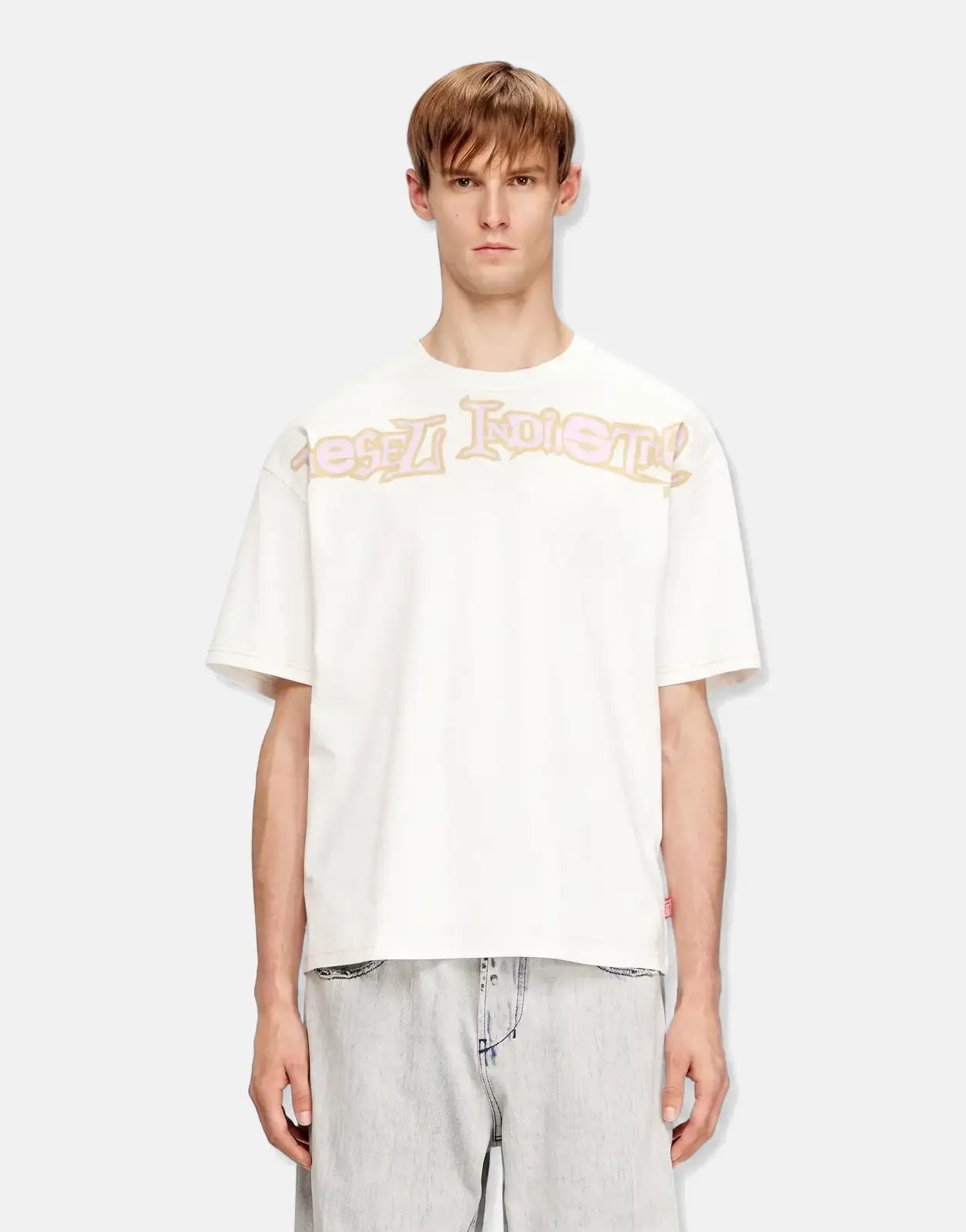 Men's white Diesel T-Boxt V3 relaxed fit t-shirt with a 'Diesel Industry' logo print, styled with light wash jeans.