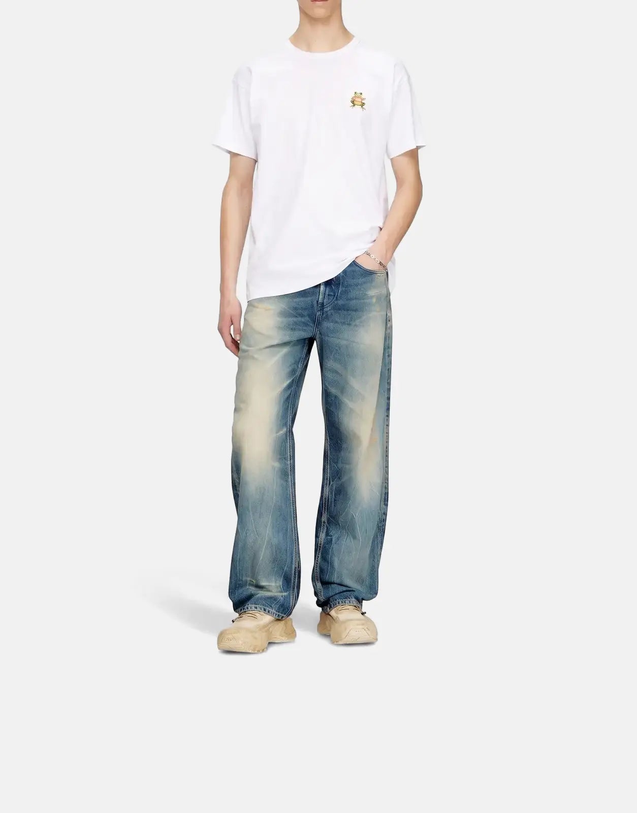 Male model in a white Diesel T-Norm Frog Regular T-Shirt with a frog graphic, paired with distressed blue jeans.