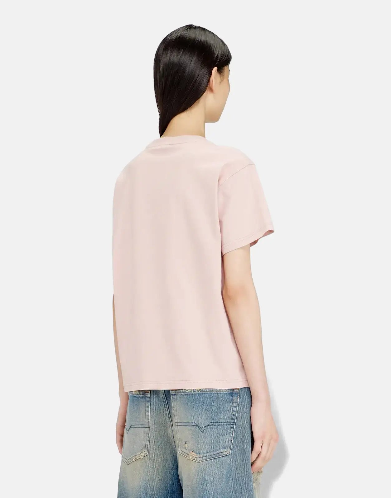 A model from the back wears a pink Diesel T-Normy S6 Regular T-Shirt, paired with blue distressed jeans.
