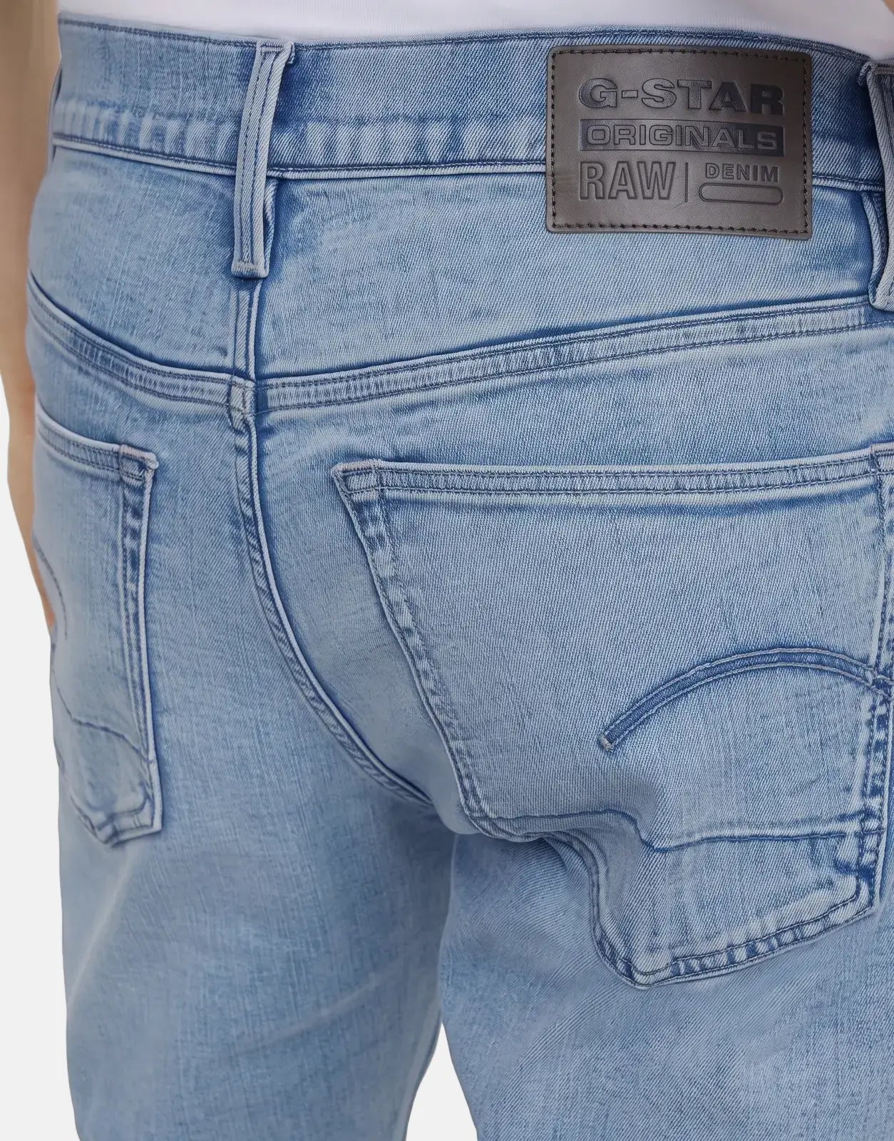 Back view of G-Star RAW 3301 Slim Lt Aged Jeans in light blue denim, featuring a branded leather patch and detailed