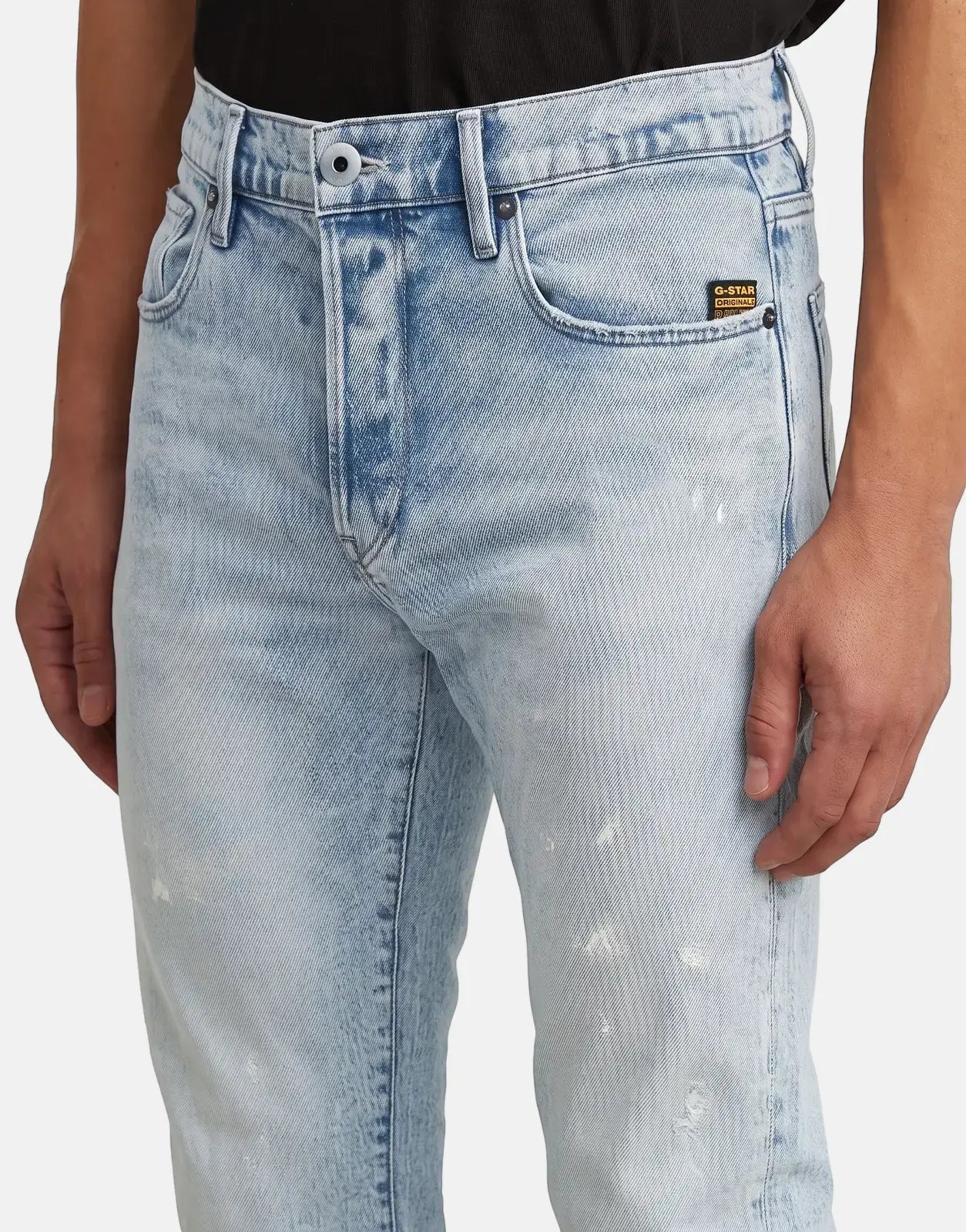 Close-up of G-Star RAW 3301 Slim Sun Faded Paint Blue men's jeans, showcasing distressed light wash denim and slim fit.