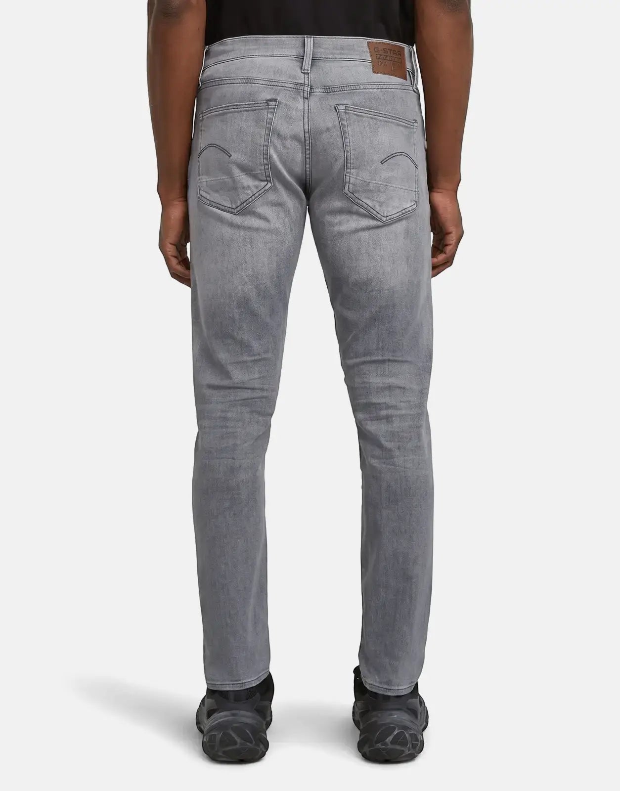 G-Star RAW 3301 Sun Faded Glacier Grey men's slim fit jeans, shown from the back, highlighting the faded wash and pocket