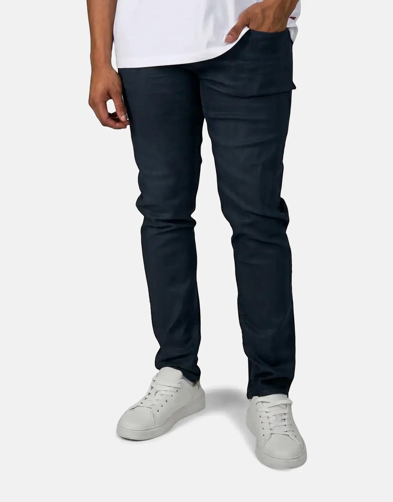 Person wearing dark blue G-Star RAW Aged Slim Blue Cobler jeans and white sneakers, shown from the waist down.