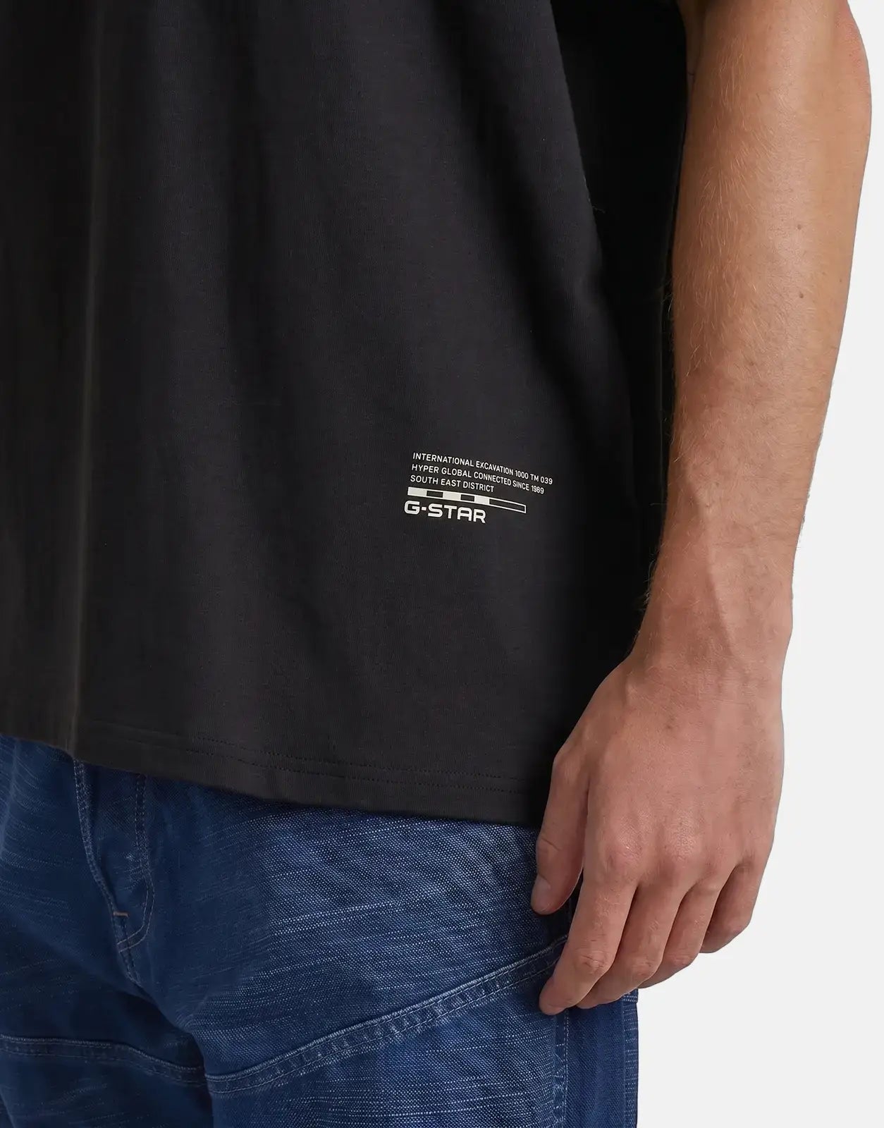 G-Star RAW Back Applique Relaxed Black T-Shirt on a model, showcasing the white logo print detail on the side, worn with