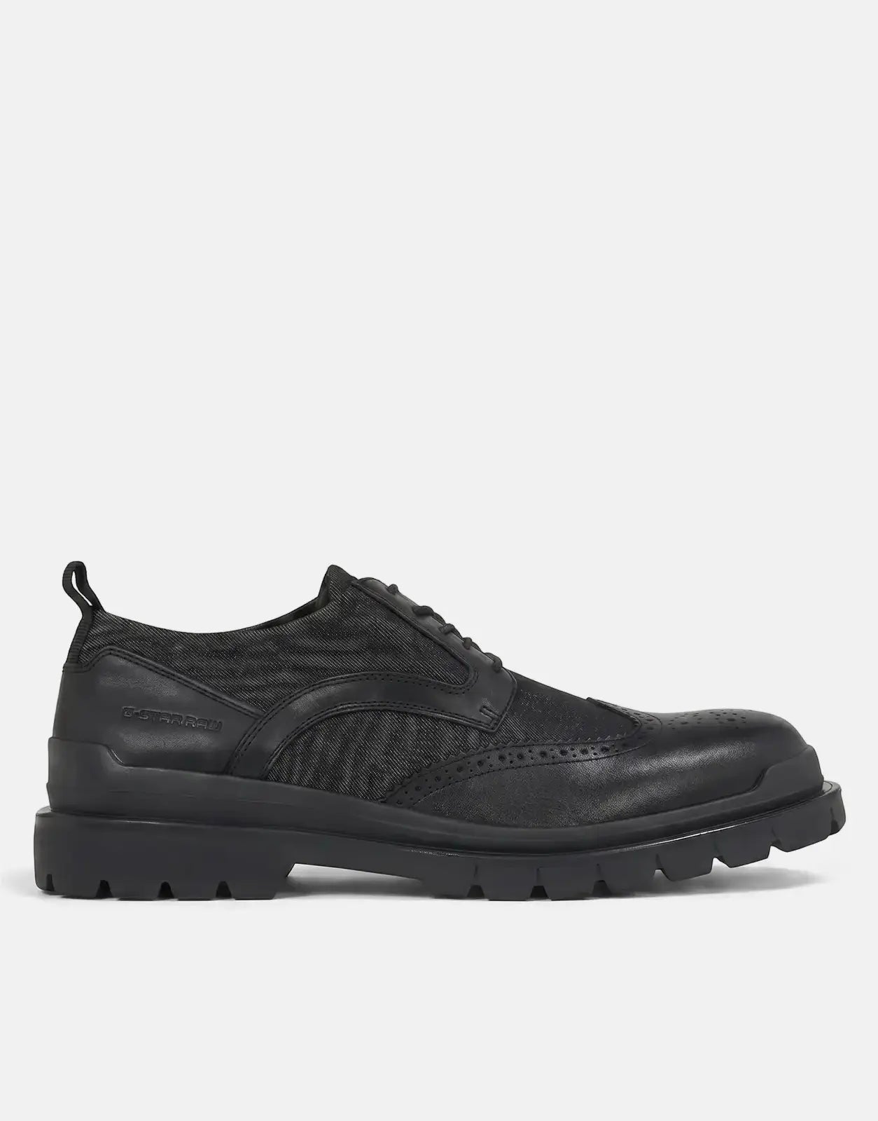 A black G-Star RAW Blake BRQ Denim shoe in a side profile view, featuring a lug sole, brogue details, and textured panels.