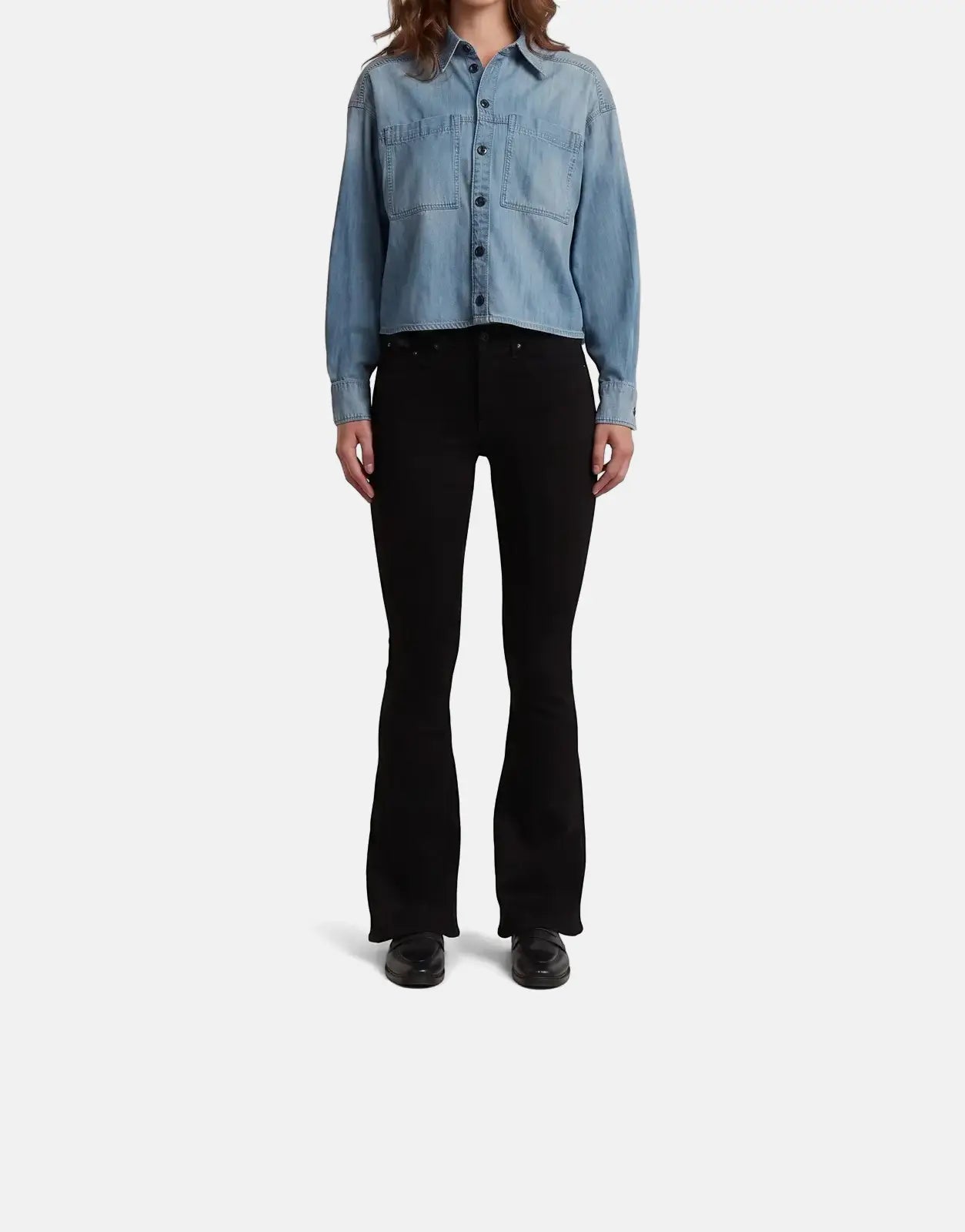 Woman in a G-Star RAW Cropped Relaxed Shirt in faded cadet blue paired with black flared jeans, full body view.