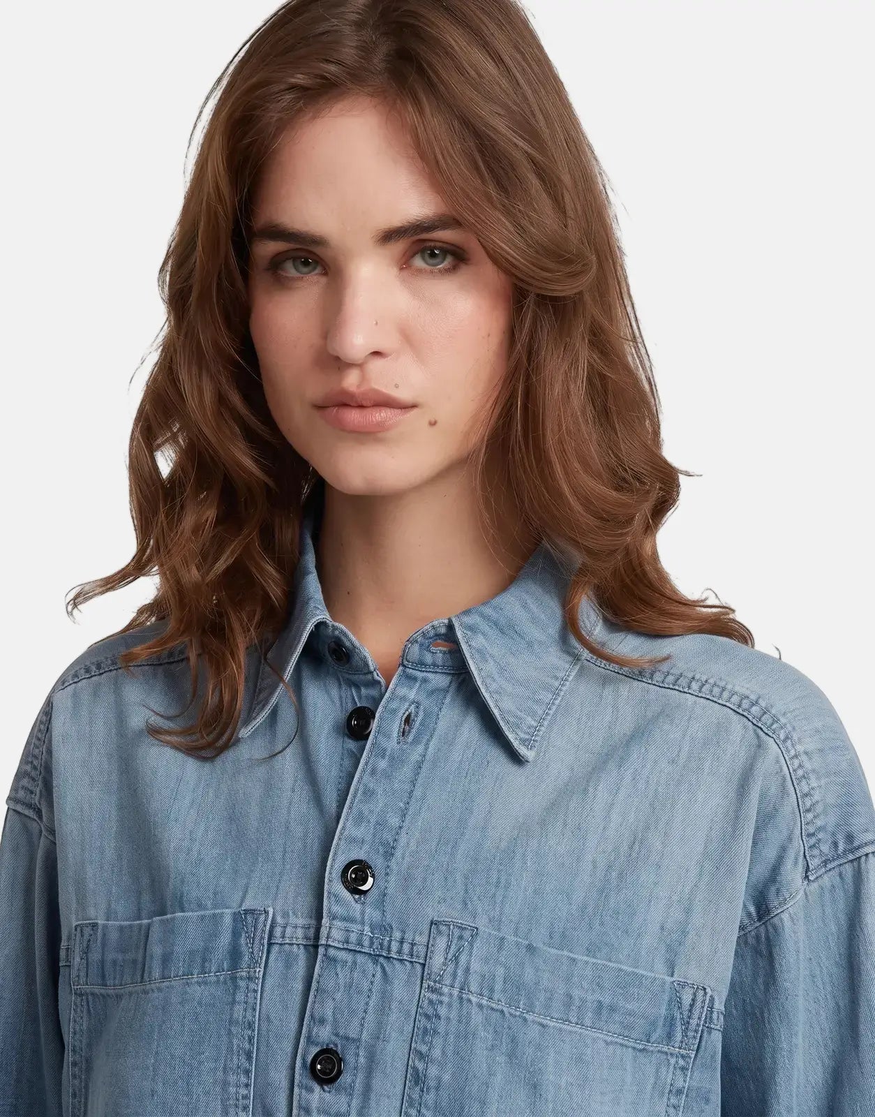 G-Star RAW Cropped Relaxed Shirt in faded cadet blue denim, worn by a female model in a chest-up view.