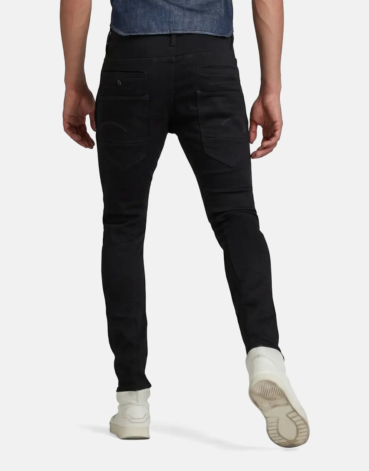 G-Star RAW D-Staq 3D Jeans in black denim, shown from the back on a male model wearing white sneakers.