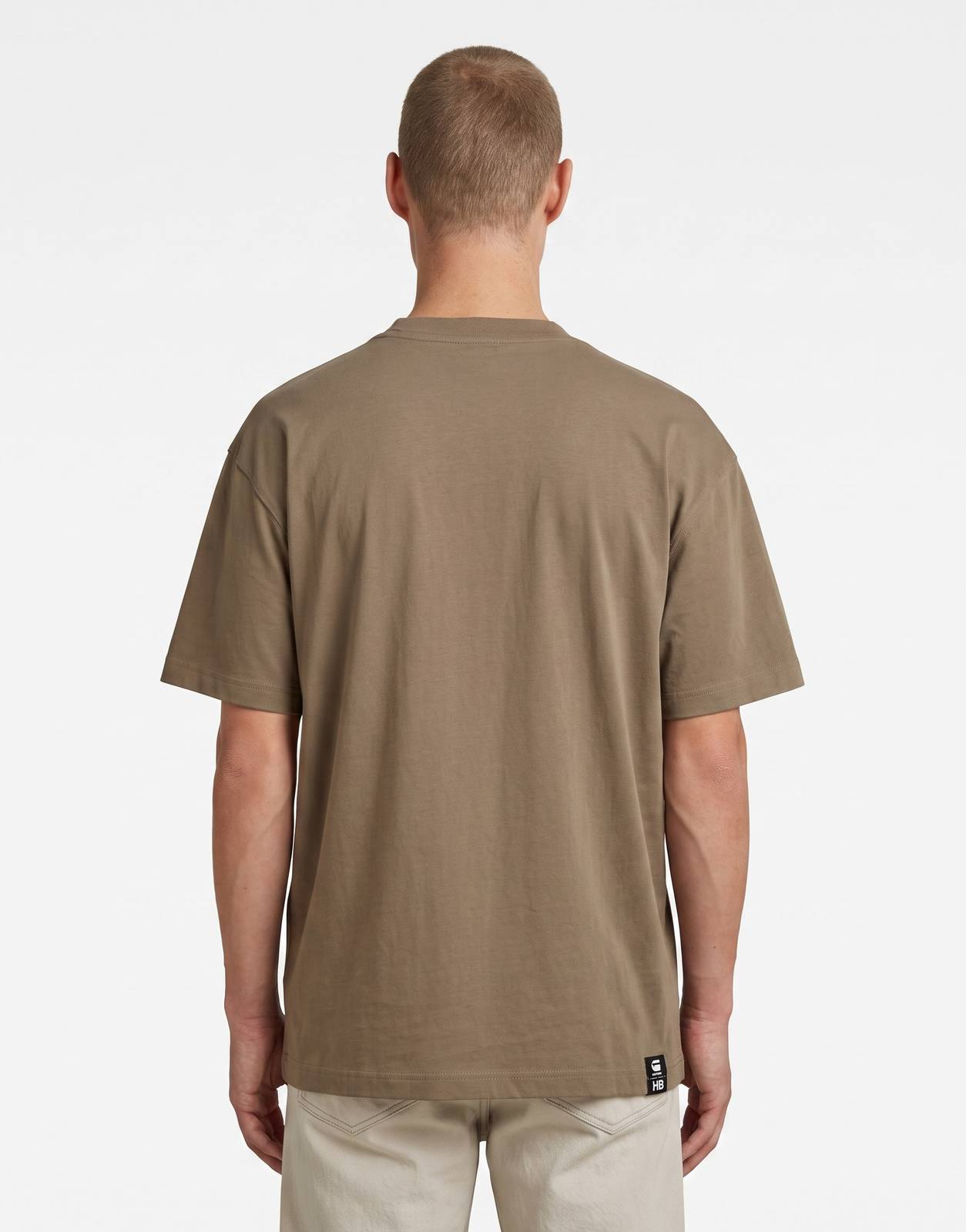 A brown G-Star RAW HB Badge Relaxed Turf men's t-shirt, presented from the back view, showcasing its relaxed fit and smooth