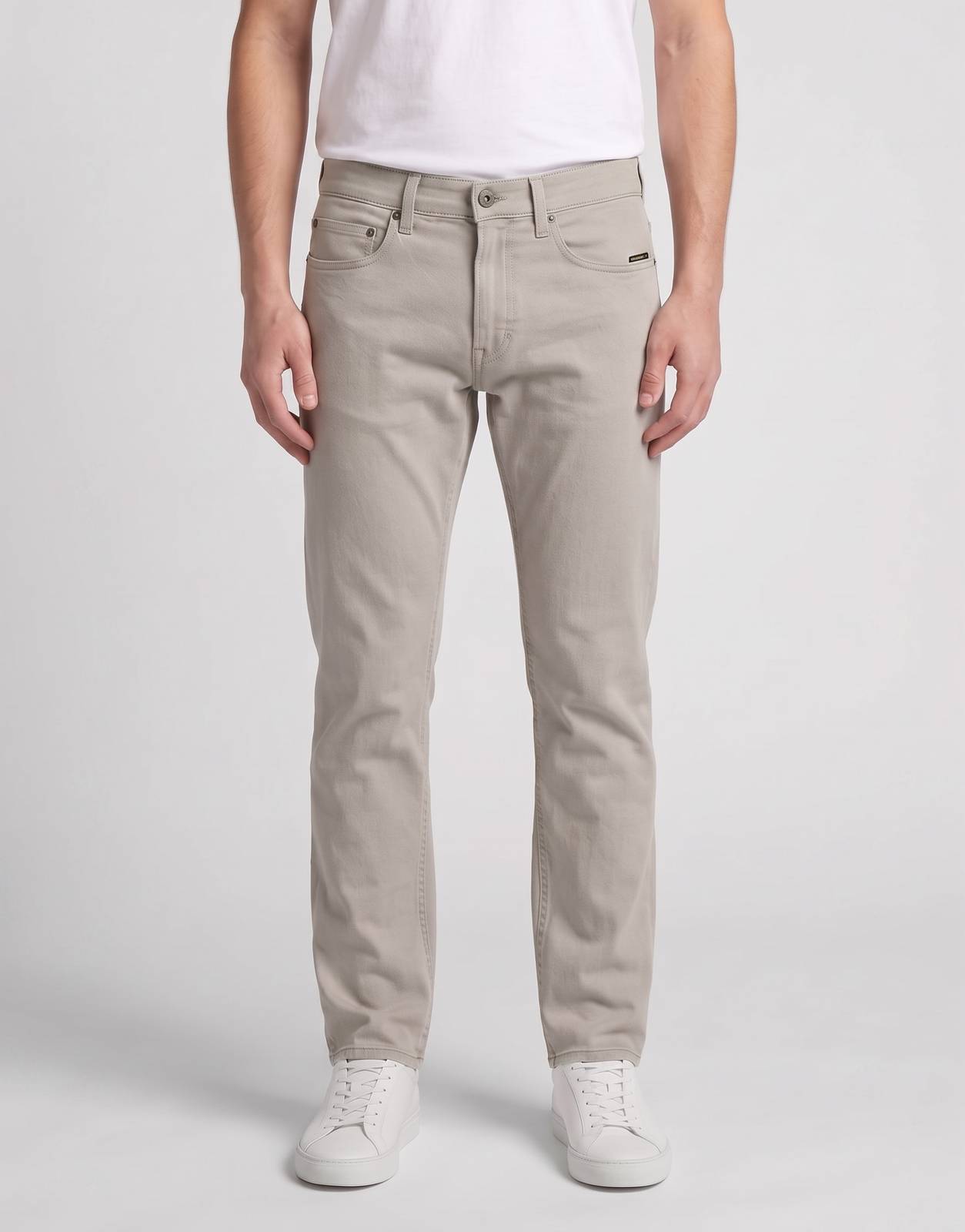 A man models G-Star RAW Mosa Straight Elephant Skin Jeans. These light taupe, straight-fit denim jeans are paired with a