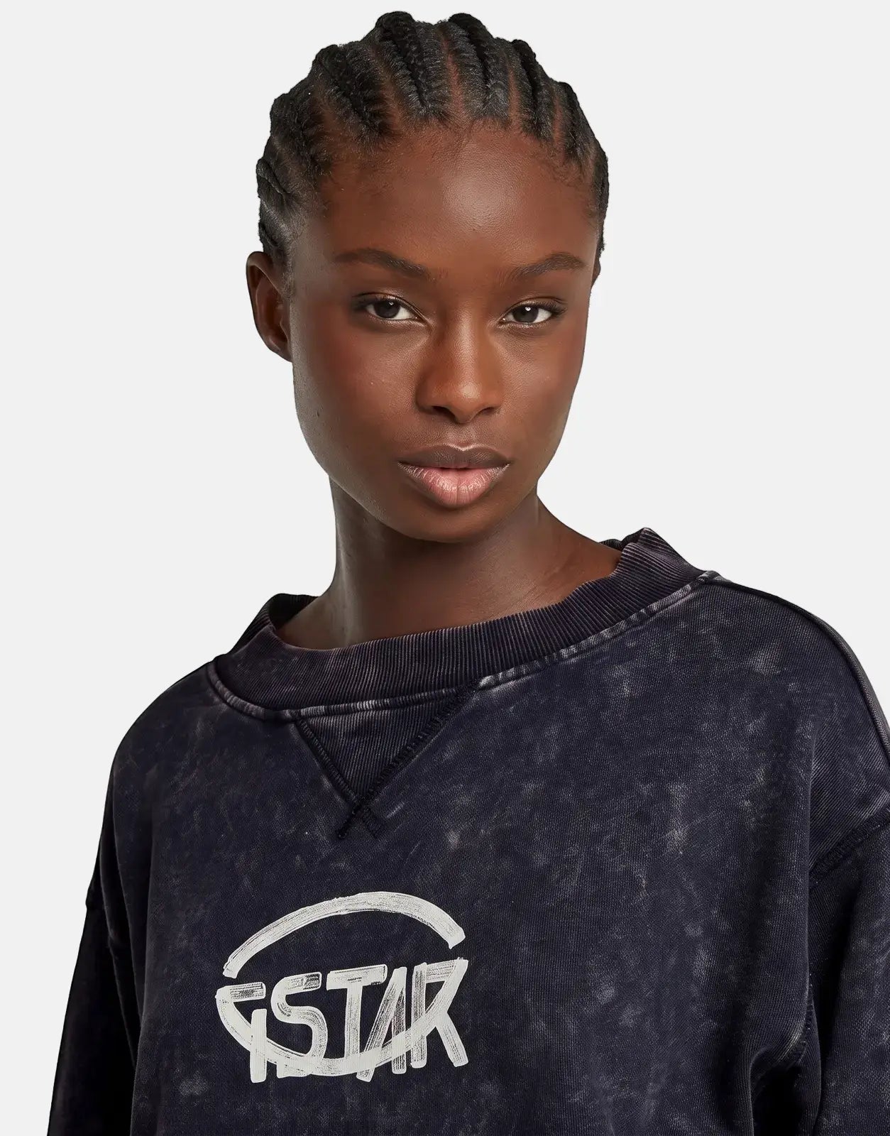 Close-up of a woman wearing a G-Star RAW Overdyed Cropped Logo sweatshirt in Osaka Blue with a distressed finish.
