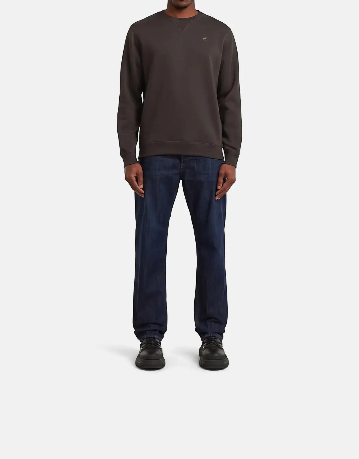 Full body view of a male model wearing a G-Star RAW Premium Core Ganache Sweatshirt with dark blue jeans and black shoes.