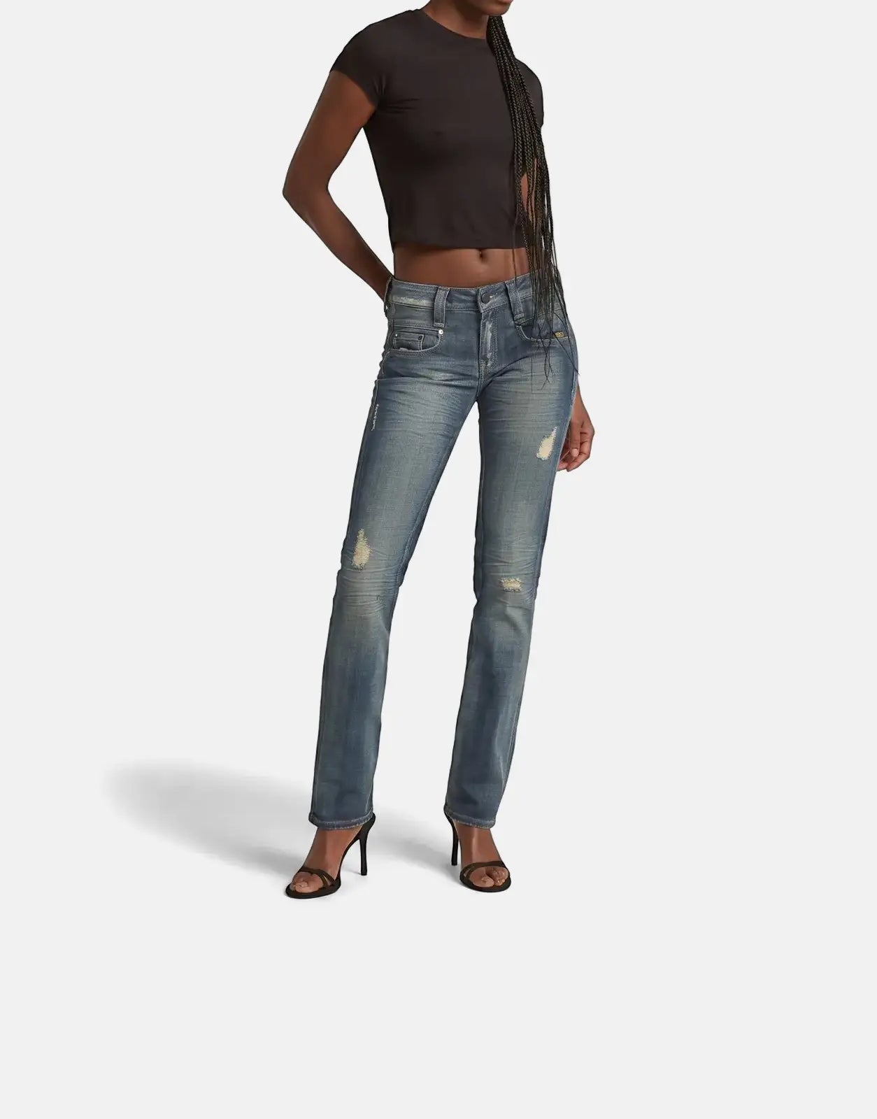 A female model wearing G-Star RAW Radar Slim Straight Vintage Desert Blue Jeans with vintage and distressed details.