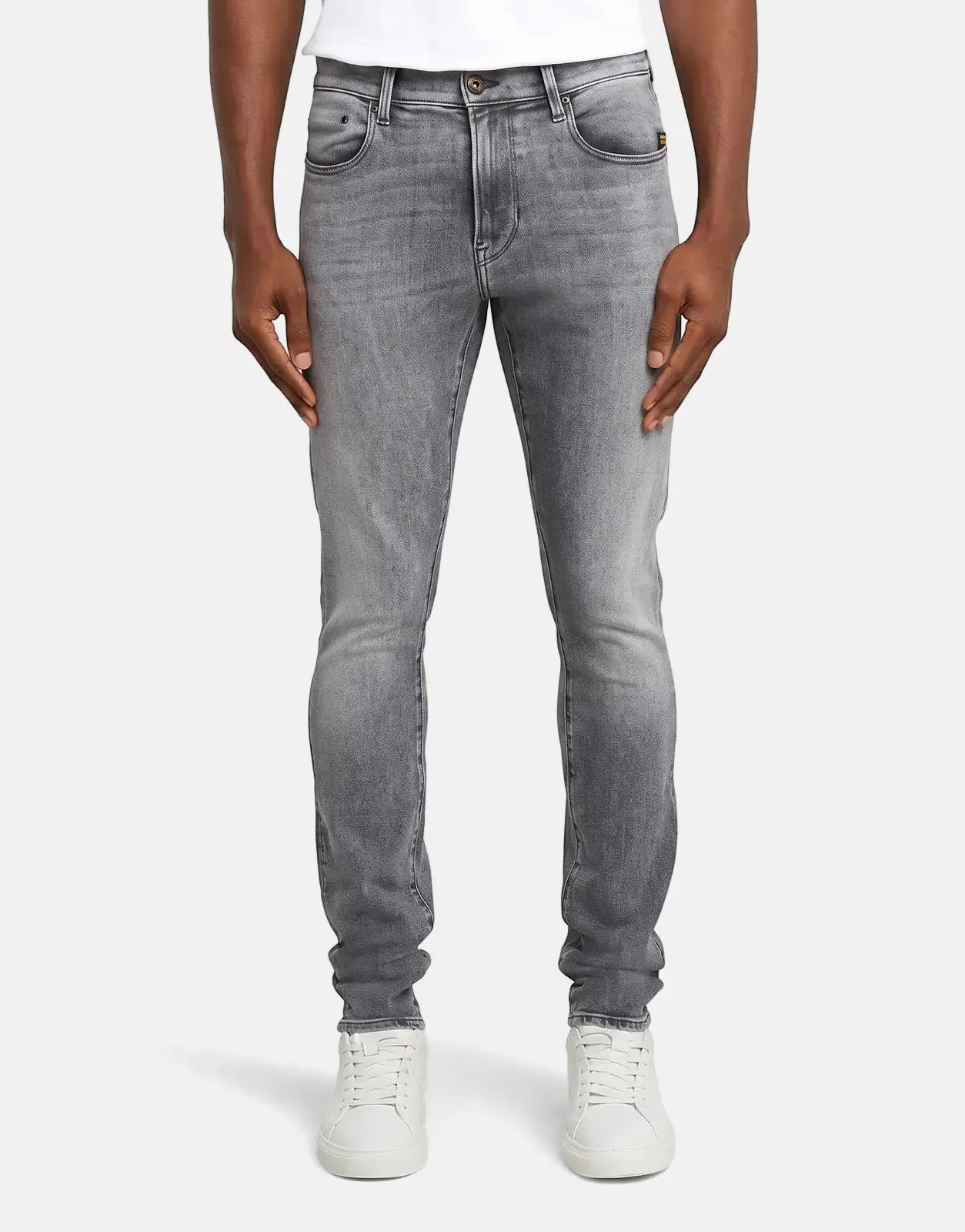 Men's G-Star RAW Revend FWD skinny jeans in faded shadow grey, showcasing a fitted style with distressed details and white