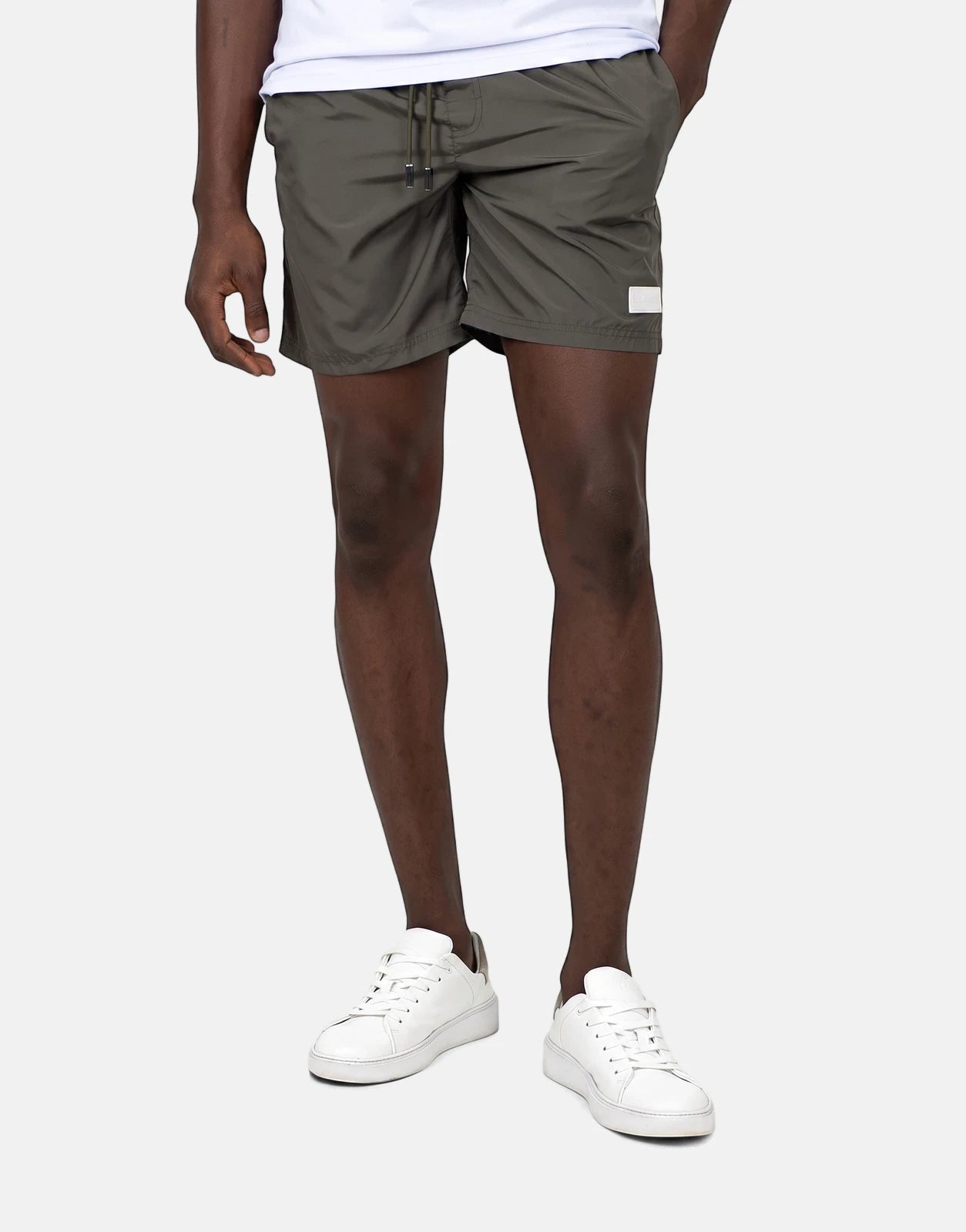 Les Hommes Colour Green Swim Shorts in olive with a drawstring waist and quick-dry fabric for beach or pool use.