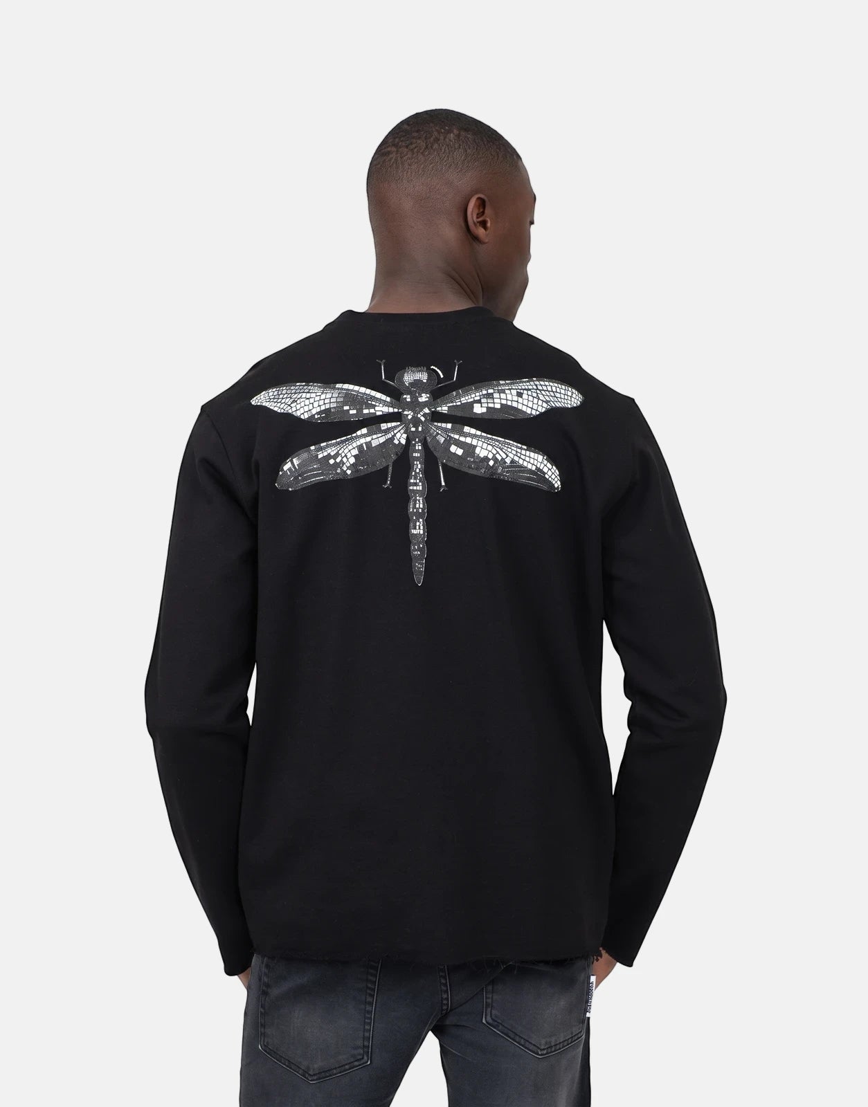 Men's Les Hommes black long-sleeve sweatshirt featuring a detailed silver mosaic dragonfly graphic on the back, shown from