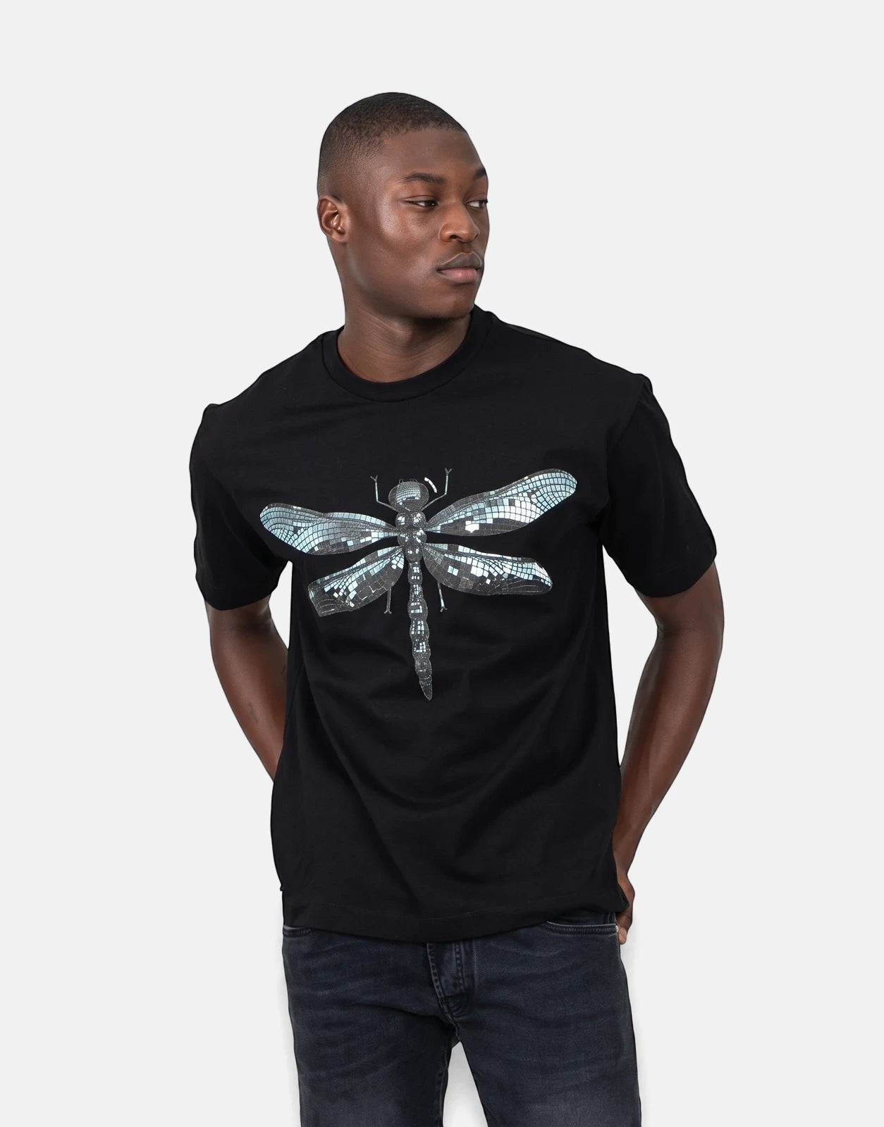 Les Hommes Dragonfly Black T-Shirt on a male model, featuring a metallic-effect mosaic dragonfly graphic on the chest.