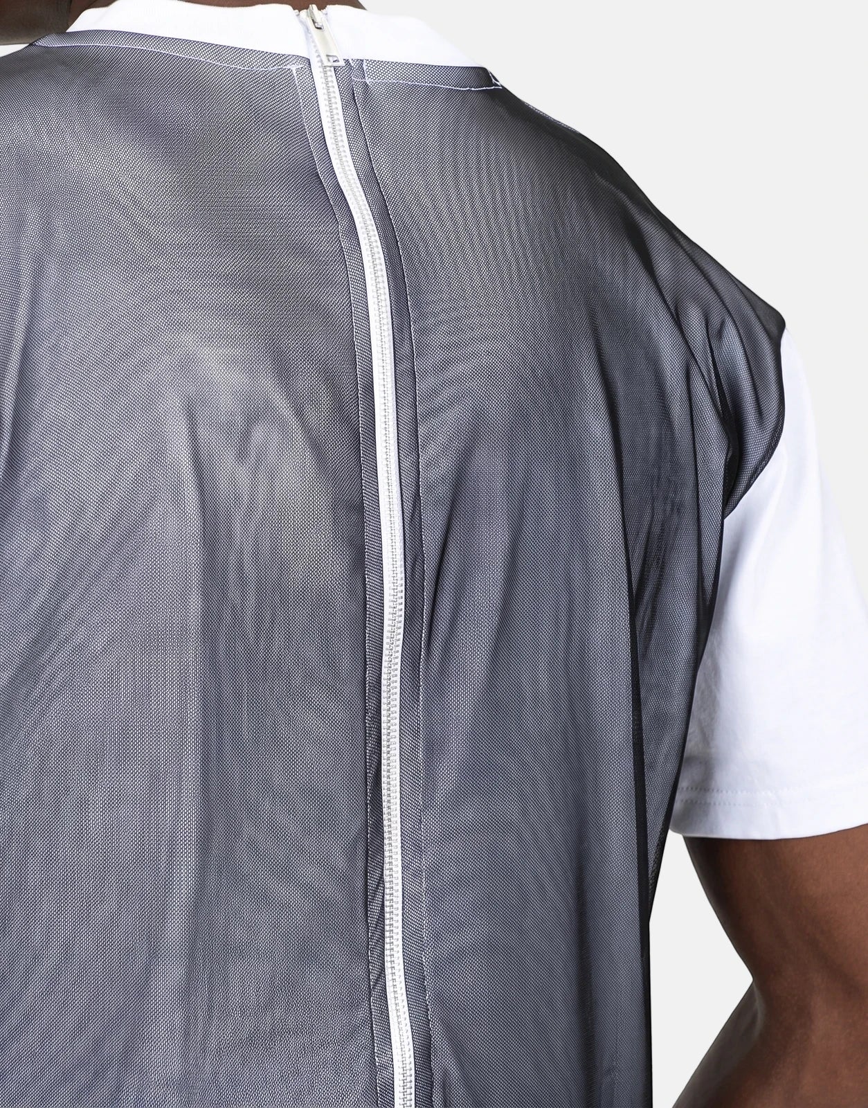 Les Hommes Tulle White T-Shirt layered under a black mesh top with a white zipper down the back, shown from a back view.