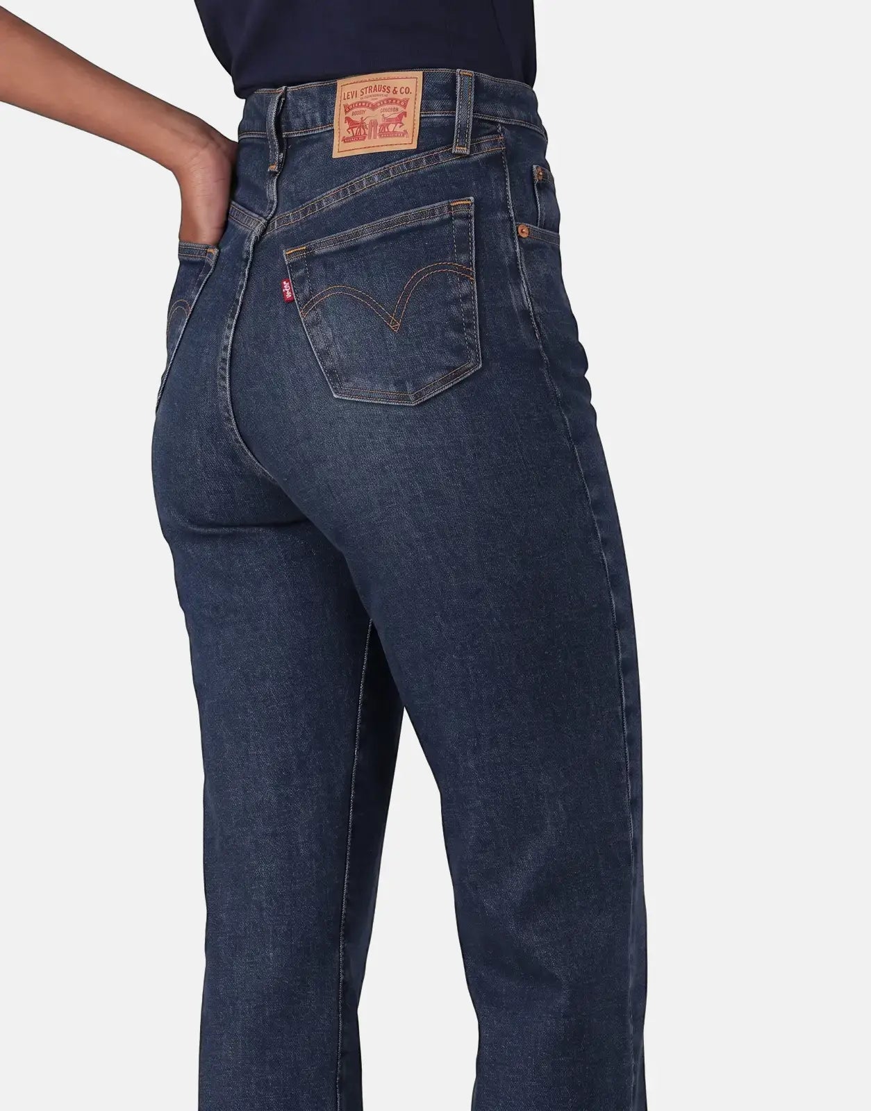 Levi's 501 Women Array Away Jeans in dark blue denim, seen from the back with a person's hand in the right back pocket,