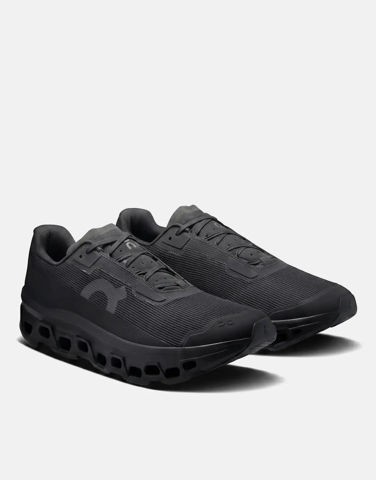 On Men's Cloudmonster Void Black running sneakers, featuring a sleek black design and innovative Cloudtec sole, displayed at