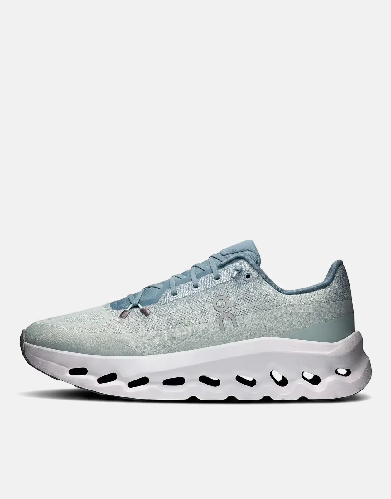 On Men's Cloudtilt Tide Mineral Sneaker, a light blue and mint green athletic shoe with a unique white holed sole, shown in