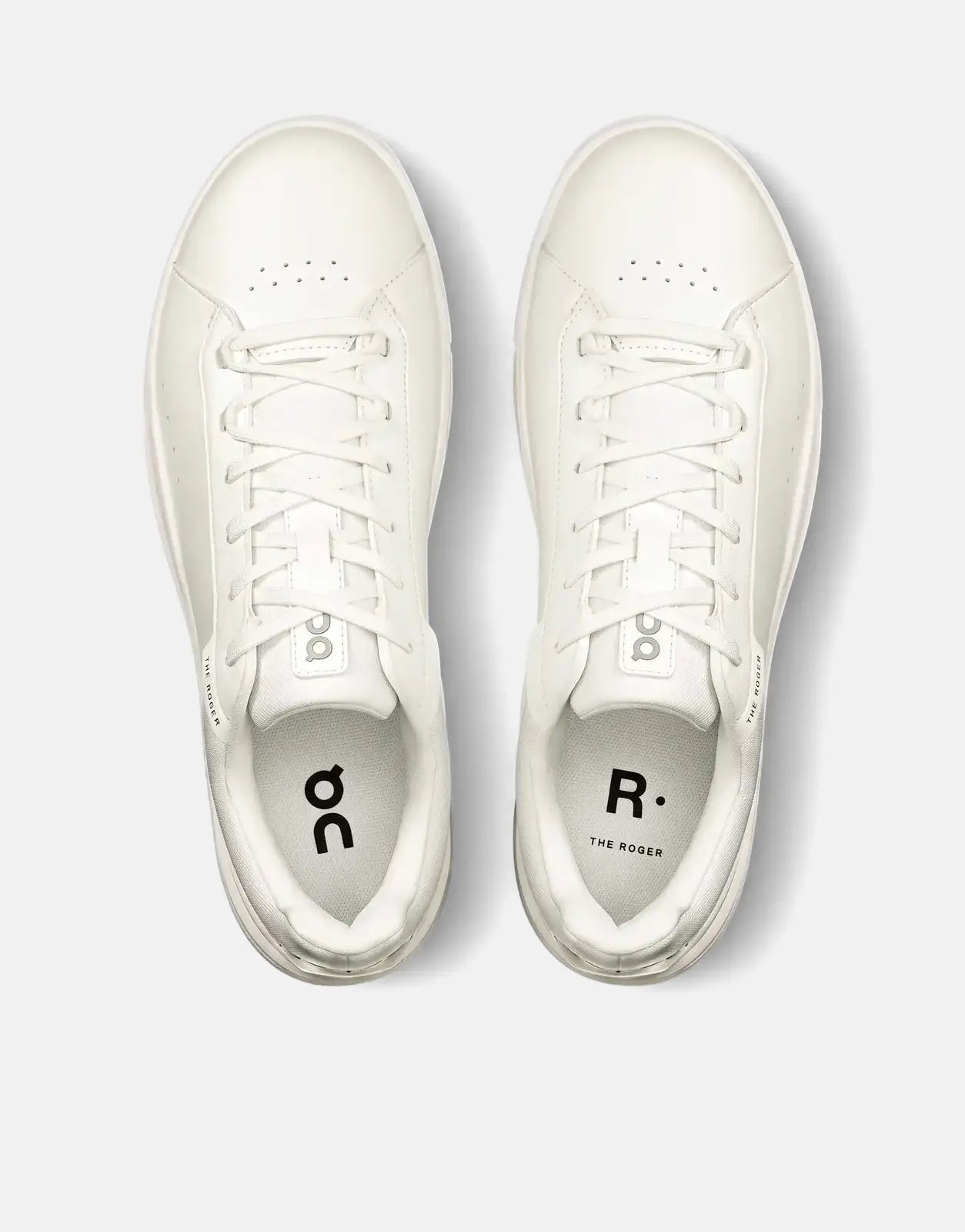 A top-down view of a pair of On Men's Roger Advantage white sneakers, featuring a clean low-top design with white laces and
