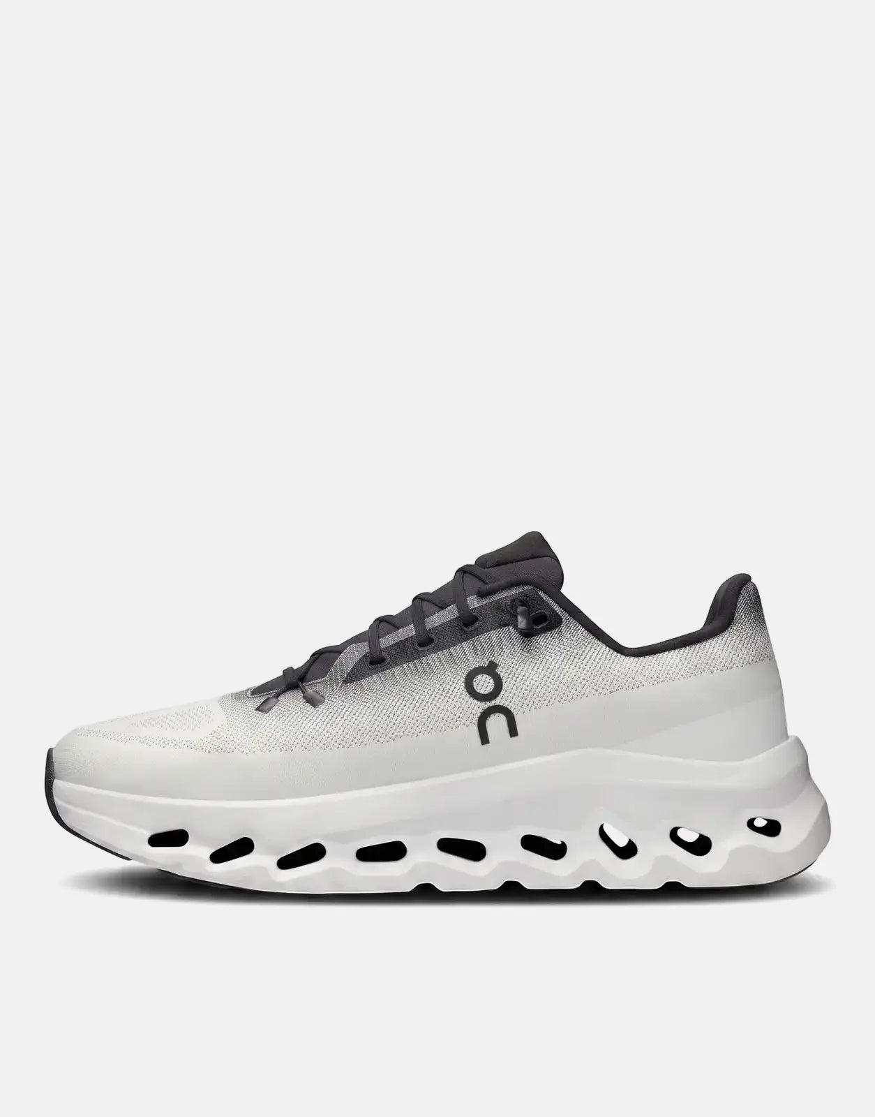 On Unisex Cloudtilt Black Ivory running sneaker in a profile view, featuring a white textured upper, dark gray laces, and a